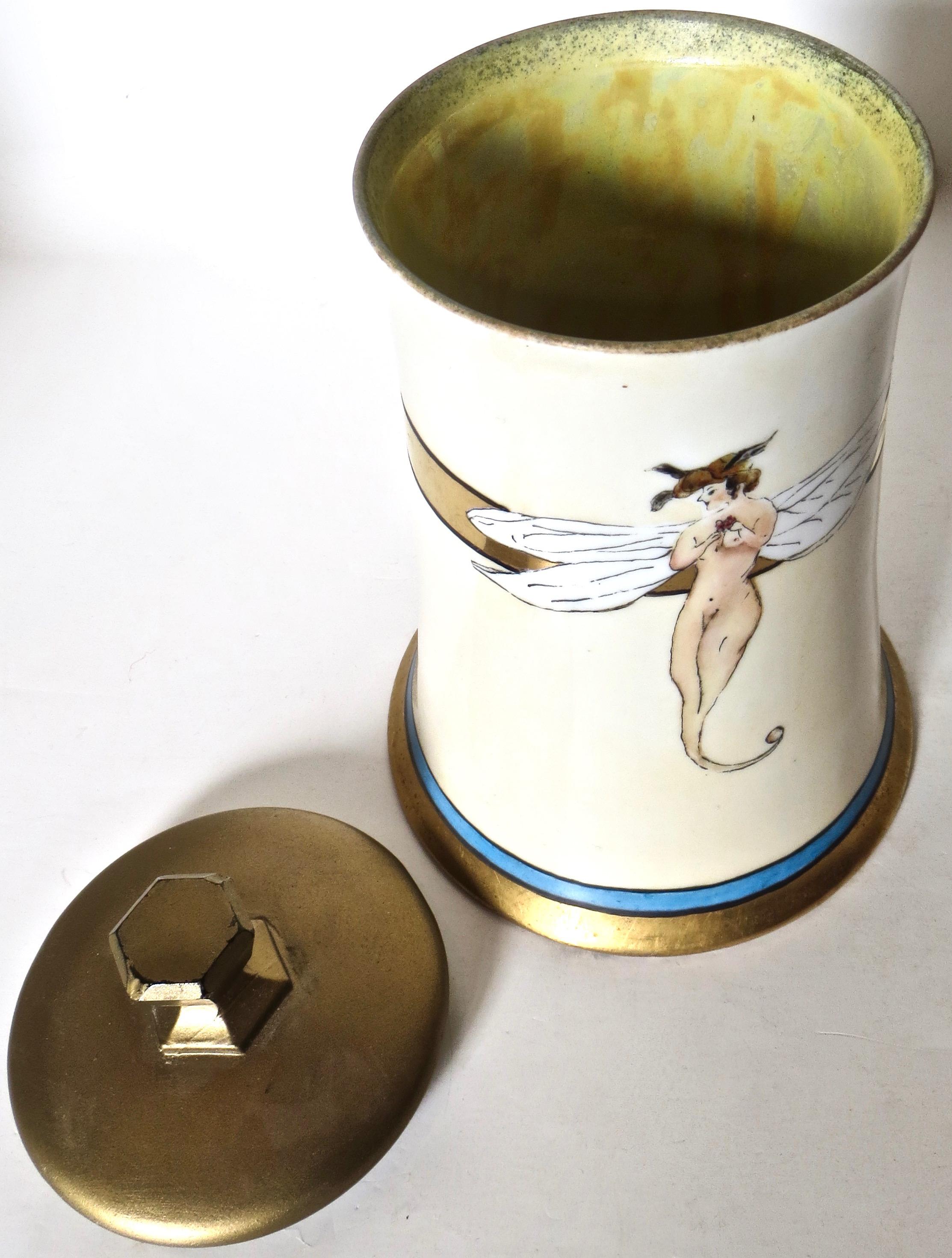 Uniquely decorated porcelain Limoges jar with a wide winged span nude woman and a duck flying out of her hair, perhaps beckoning her to join in the flight. Her legs and feet end as one 