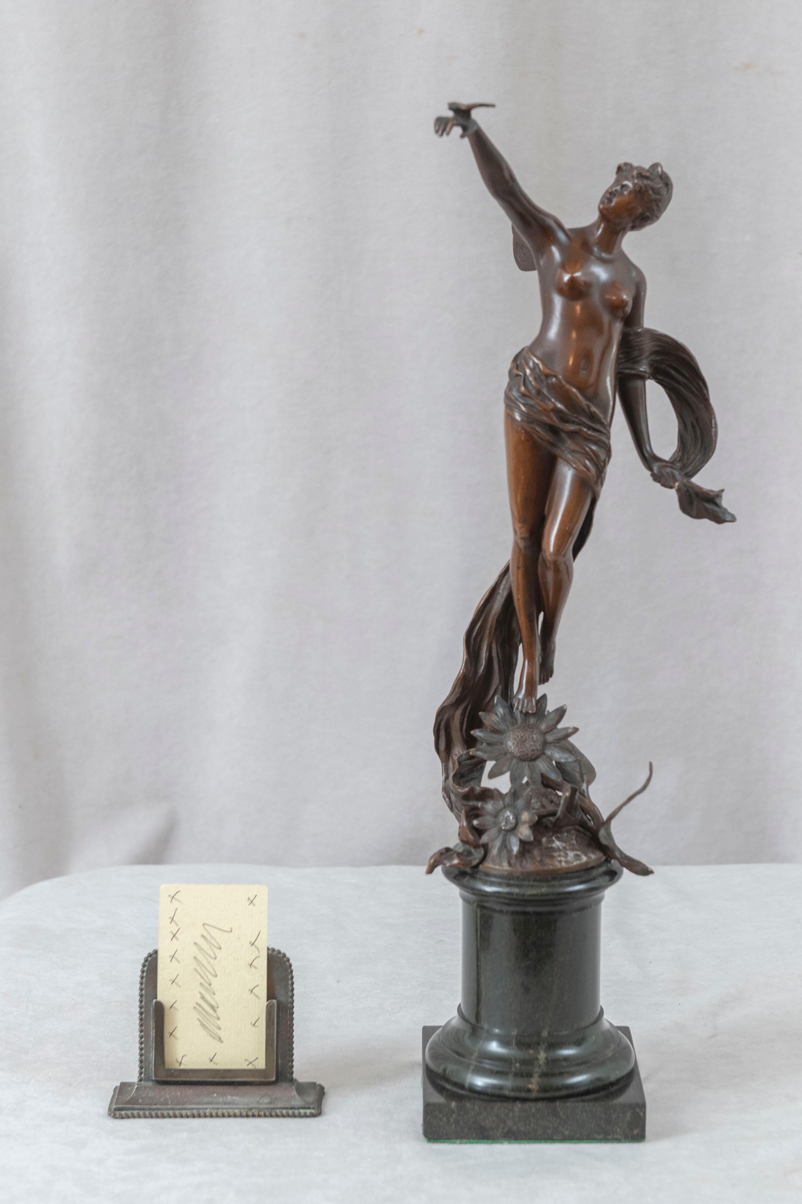  This lovely bronze is the epitome of art nouveau movement. The stylized nature themes, flowers, movement, and a young girl who has butterfly wings and is holding a bird in her hand. The return to nature is what is a predominant theme of art