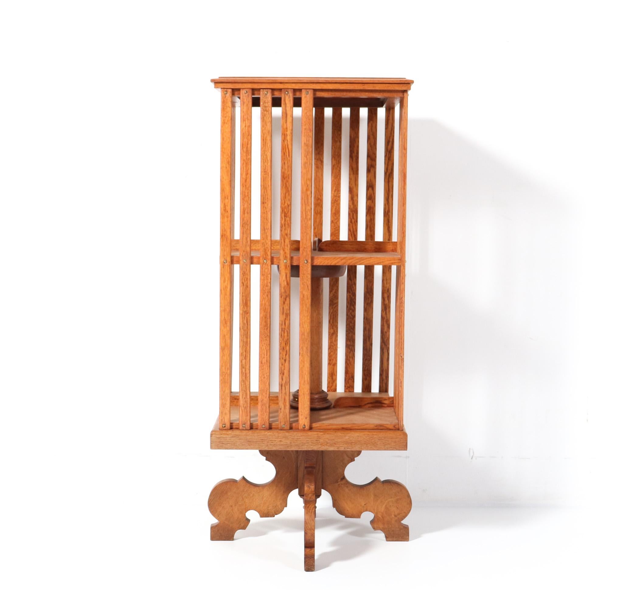 Stunning and elegant  Art Nouveau Jugendstil revolving bookcase. Striking Dutch design from the 1900s. Solid oak and the wheels are in good working order. This wonderful Art Nouveau Jugendstil revolving bookcase is in very good condition with minor