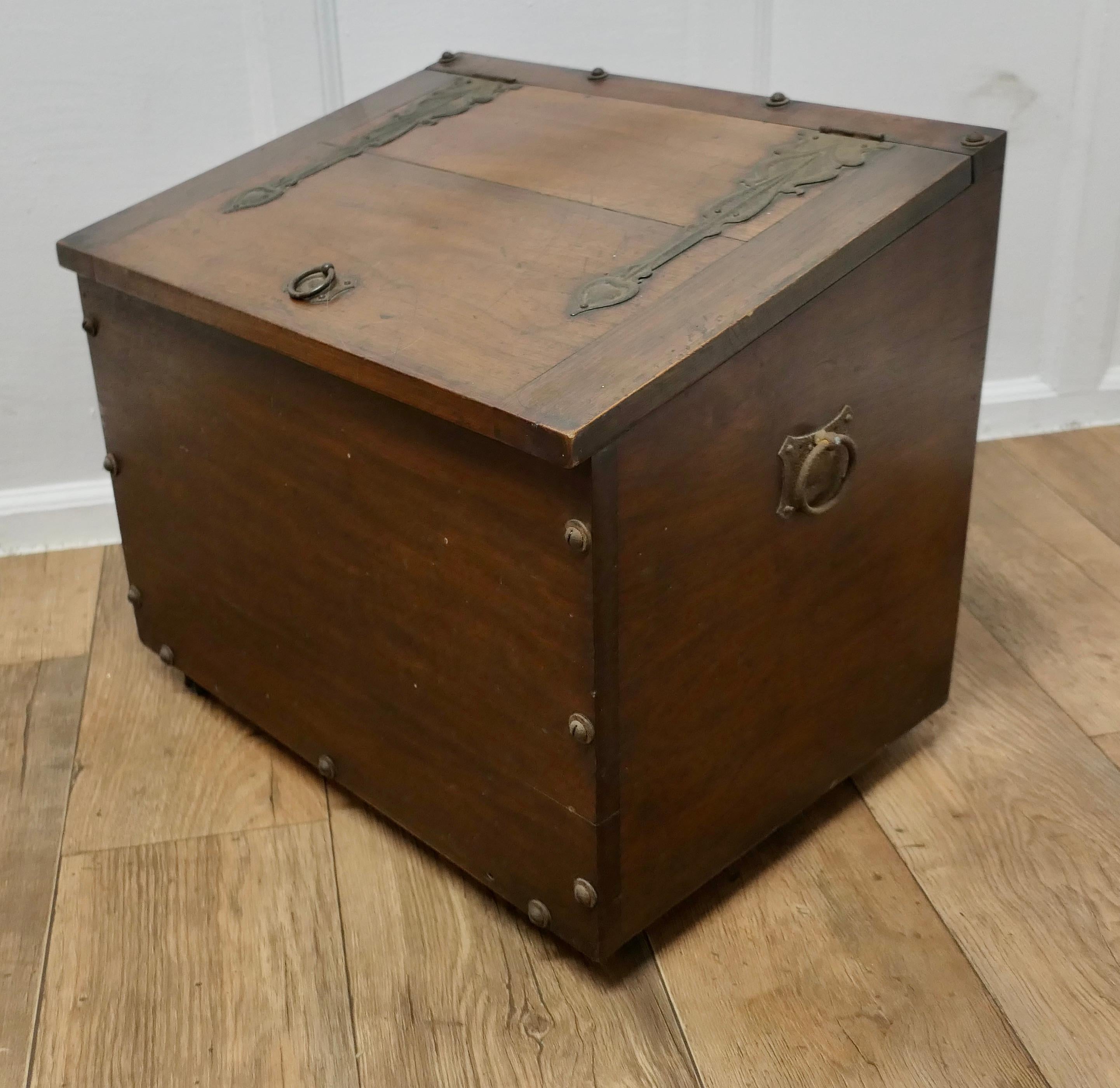 Art Nouveau  Log or Storage Box

This big log box is made in solid walnut, it has decorative Iron hinges and hand made studs, it has ring handles at the top and both sides.
This is a large box with many potential uses not least, it would make a