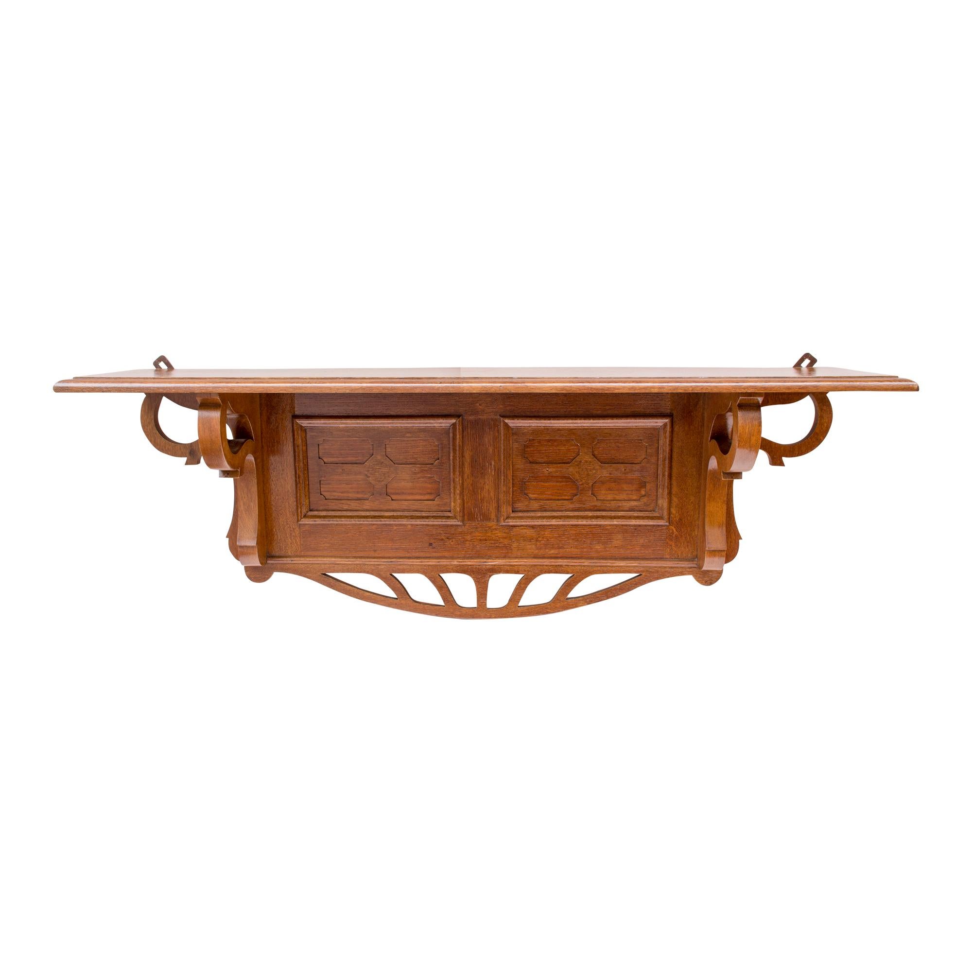 This unique hanging shelf is from the Art Nouveau period from Germany around 1895. The shelf is hung on the wall with two original eyelets. The shelf was made of oak and is hand polished in good condition. 
A very beautiful classic German Art