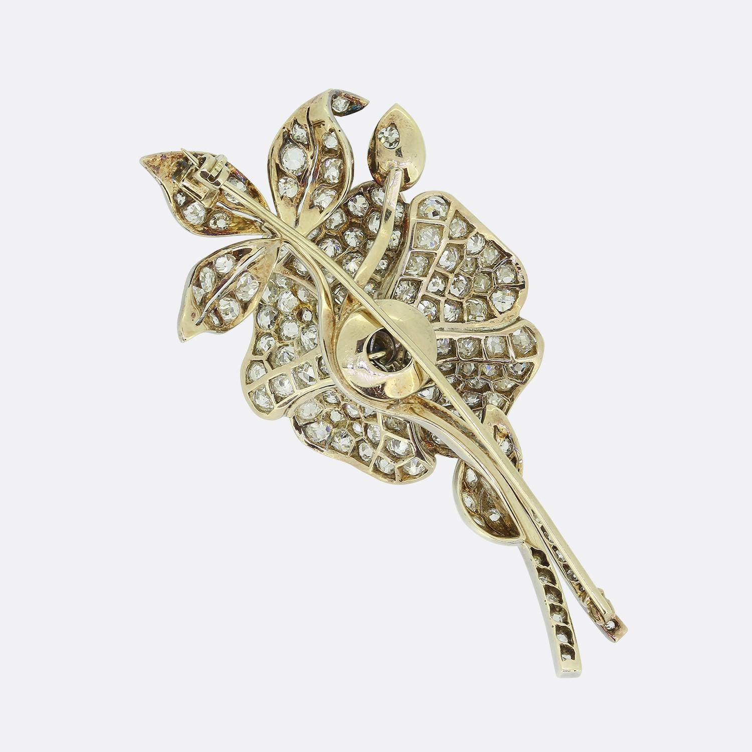 Here we have a stunning diamond brooch crafted during the late Victorian era. This piece has been exceptionally handcrafted from 18ct yellow gold into the shape of a flower with the edges tipped in platinum. The flower head, petals and stem have all