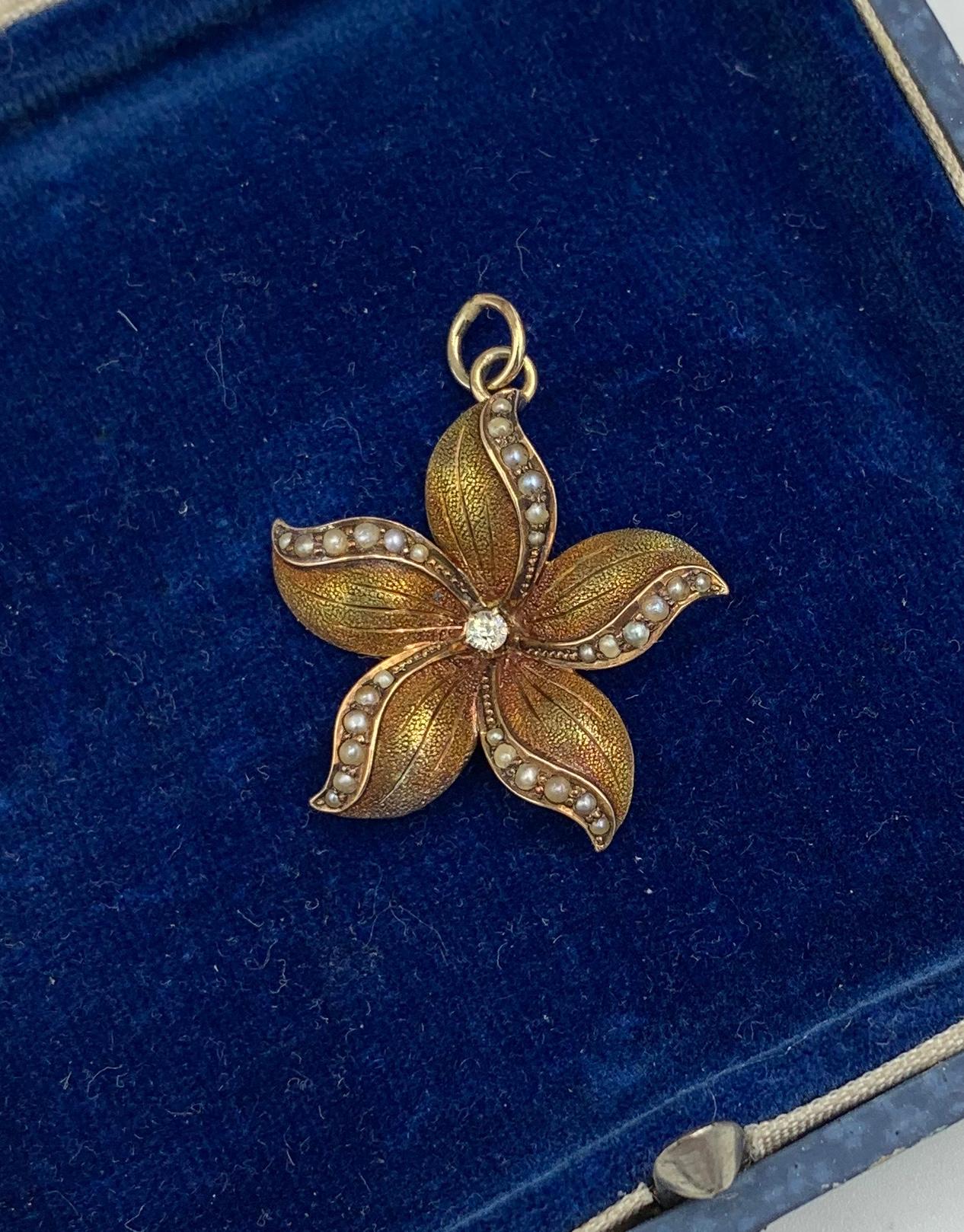 A VICTORIAN - ART NOUVEAU PENDANT OR CHARM IN THE FORM OF A FLOWER - SO STUNNING WITH THE MOST WONDERFUL THREE DIMENSIONAL DEPICTION OF THE FLOWER.   THE GOLD WORK IS OF THE HIGHEST QUALITY AND SET WITH A RADIANT ANTIQUE OLD MINE CUT DIAMOND OF