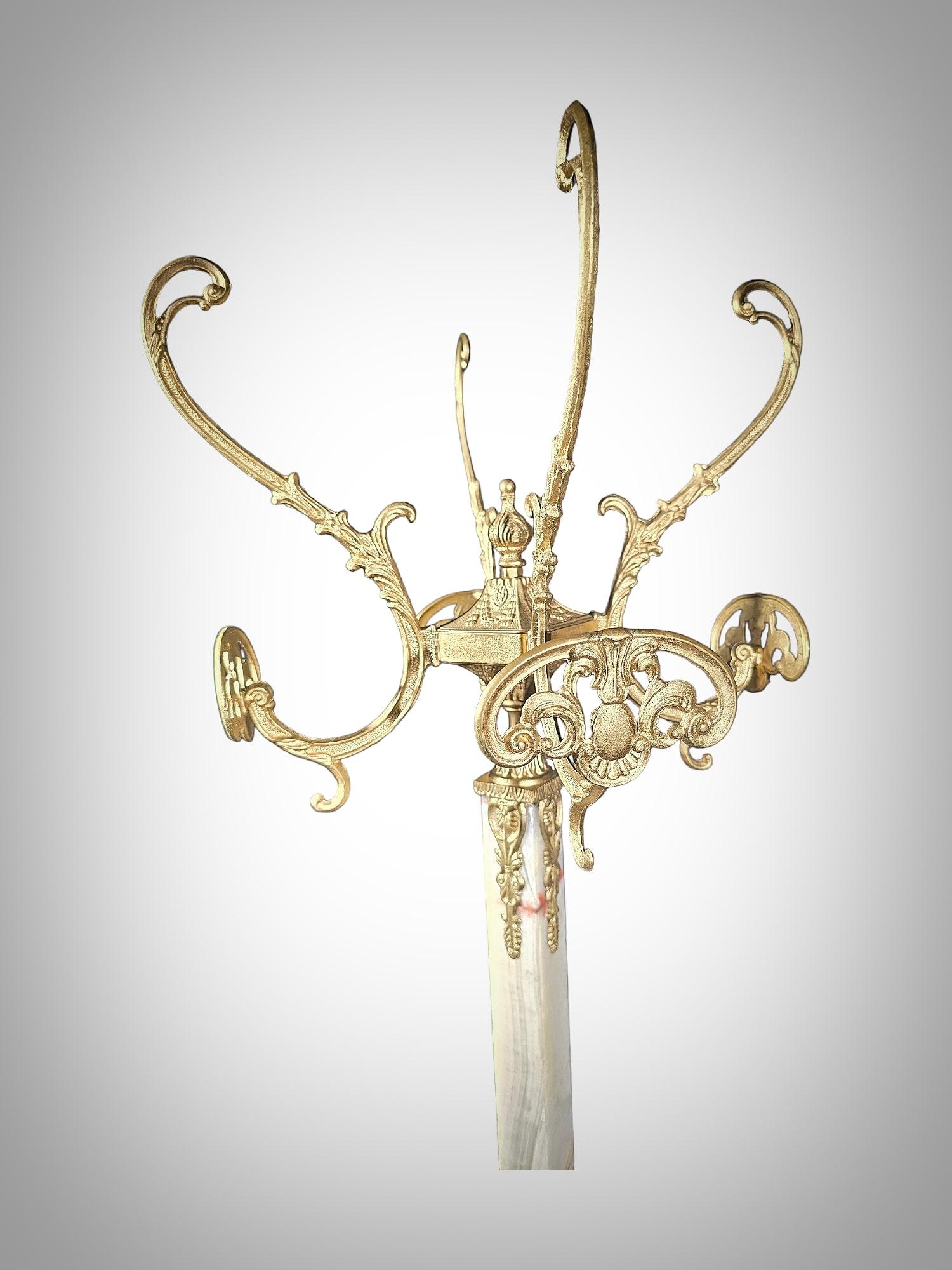 Add a touch of elegance and sophistication to your interior with this exquisite onyx and gilt bronze coat rack, in the Art Nouveau style, dating back to the 1900s. This piece exudes the characteristic charm and grace of the era, serving as a true