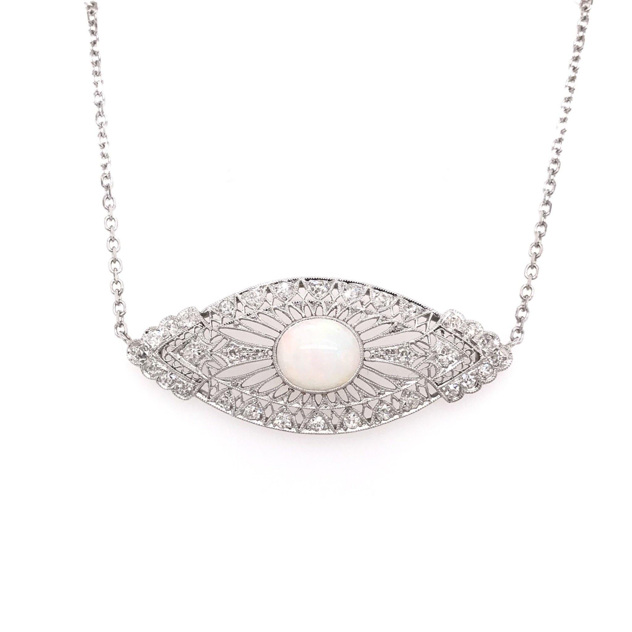 This piece is an antique revision made from reclaimed antique materials. This necklace was originally an antique brooch handcrafted sometime during the Art Nouveau design period ( 1890 -1910 ). The platinum pendant features 32 sparkling diamond
