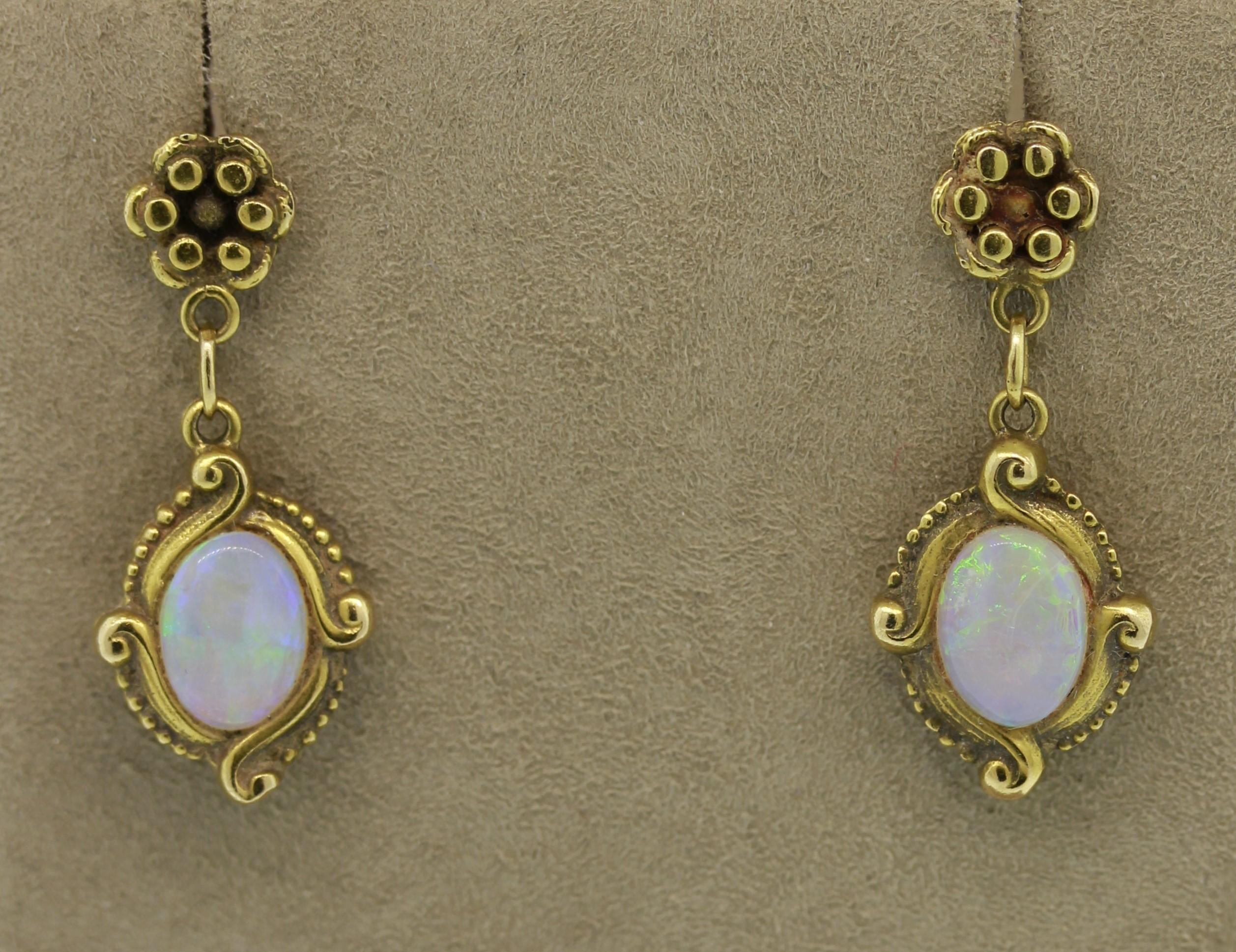 An Art Nouveau treasure from the turn of the 20th century, there earrings feature 2 Australian crystal opals. They are set in hand fabricated 14k yellow gold with filigree work around the setting and flowers studded on top.

 

Length: 1 inch