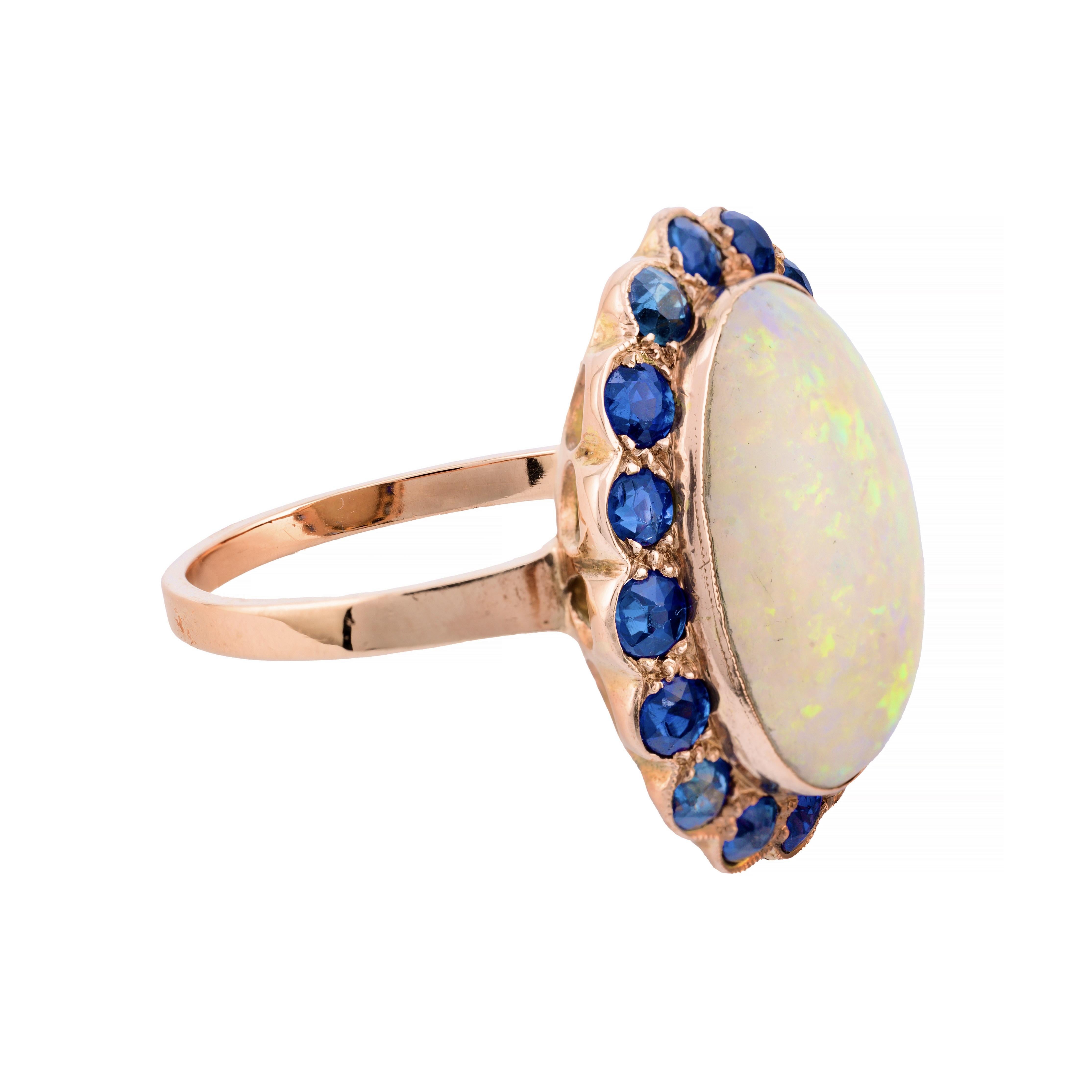 Aston Estate Jewelry Presents:

A captivating art nouveau opal ring featuring a 5.20 carat cabochon Australian opal, showcasing a mesmerizing white hue. In excellent condition free of any crazing, the vibrant opals boasts beautiful flashes of blue,