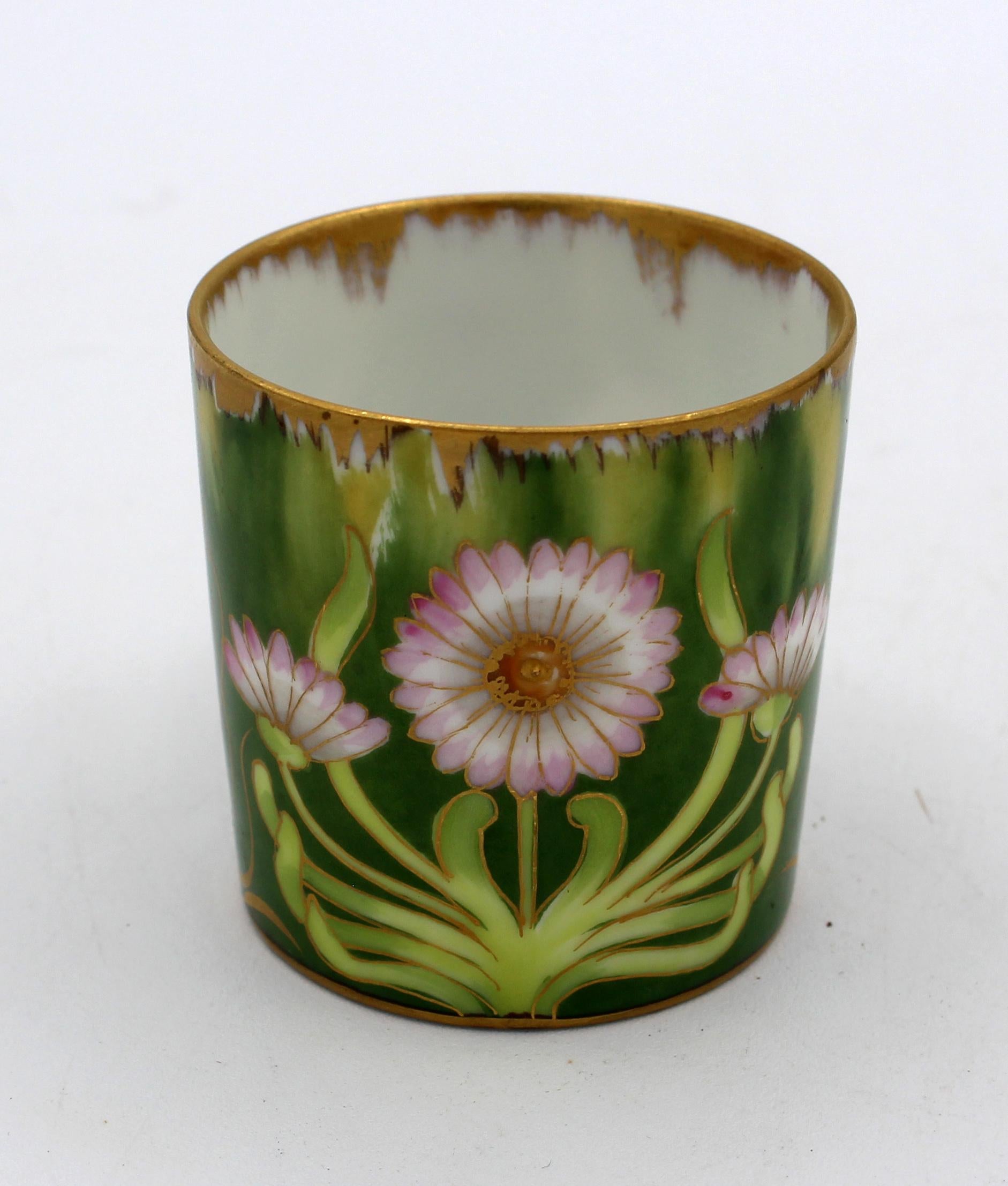 Art Nouveau or Jugendstil period demitasse cup & saucer by Nymphenburg, Germany. Underglaze blue shield & Nymphenburg mark with red overglaze: 467C, XIII. Tiny flake on inside of cup base rim. Includes a modern stand. Saucer: 3.75