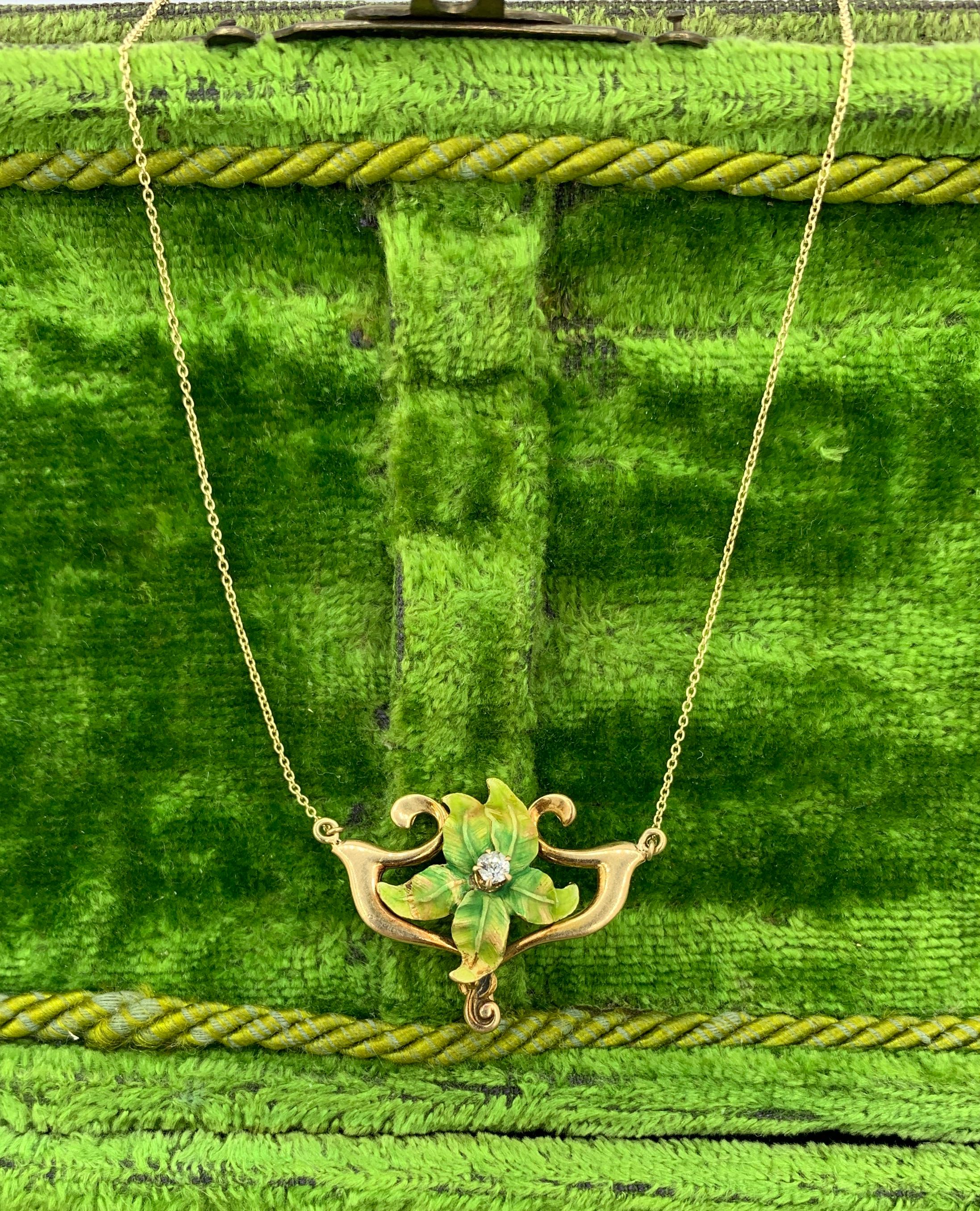 THIS IS A GORGEOUS VICTORIAN - ART NOUVEAU PENDANT NECKLACE WITH A BEAUTIFUL GREEN ENAMEL ORCHID FLOWER WITH AN OLD MINE CUT DIAMOND IN THE CENTER.  THE FLOWER IS SET IN AN ELEGANT GOLD RIBBON SURROUND WITH LOVELY ART NOUVEAU DESIGN.  THE PENDANT