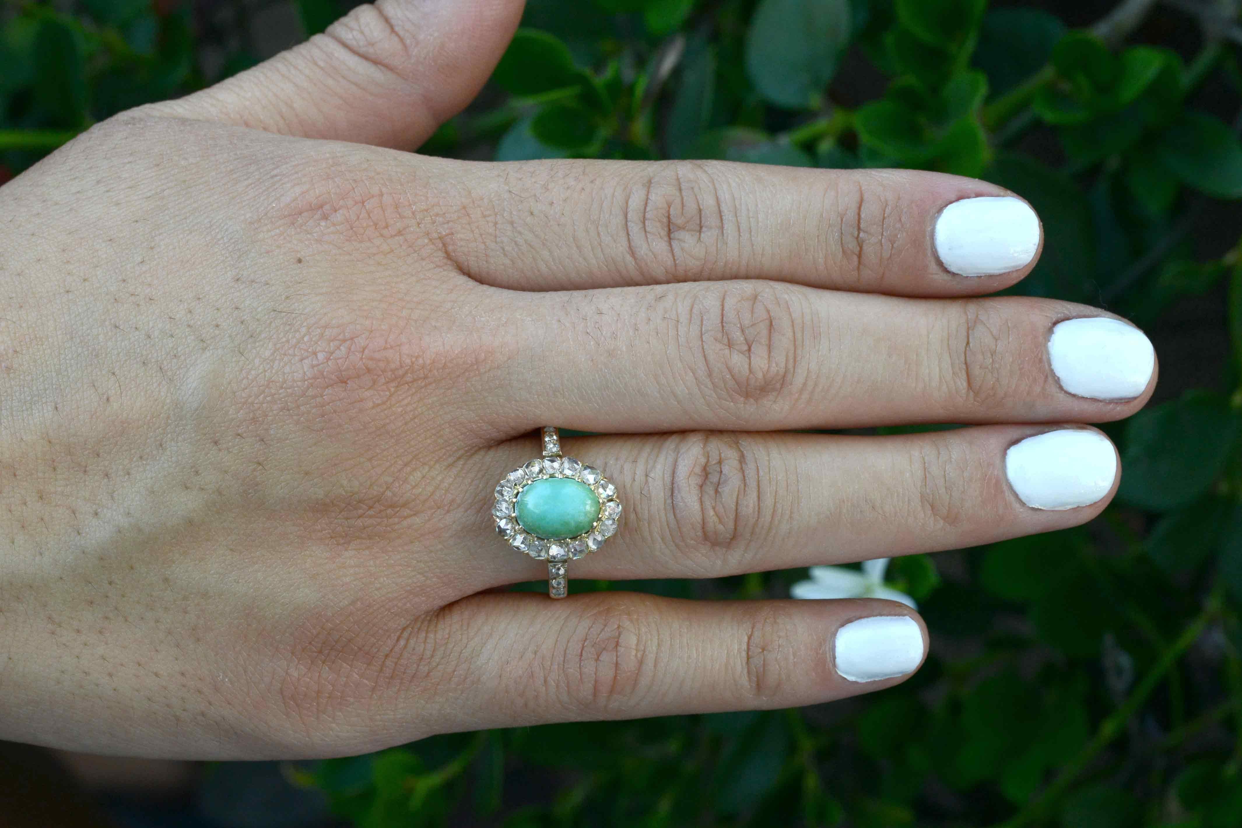 The Santa Rosa Cluster Engagement Ring. Centered by a vibrant robin's egg blue Persian Turquoise and surrounded by a twinkling halo of rose cut diamonds, this original, antique stunner from the Art Nouveau era is fabulous wardrobe essential. You