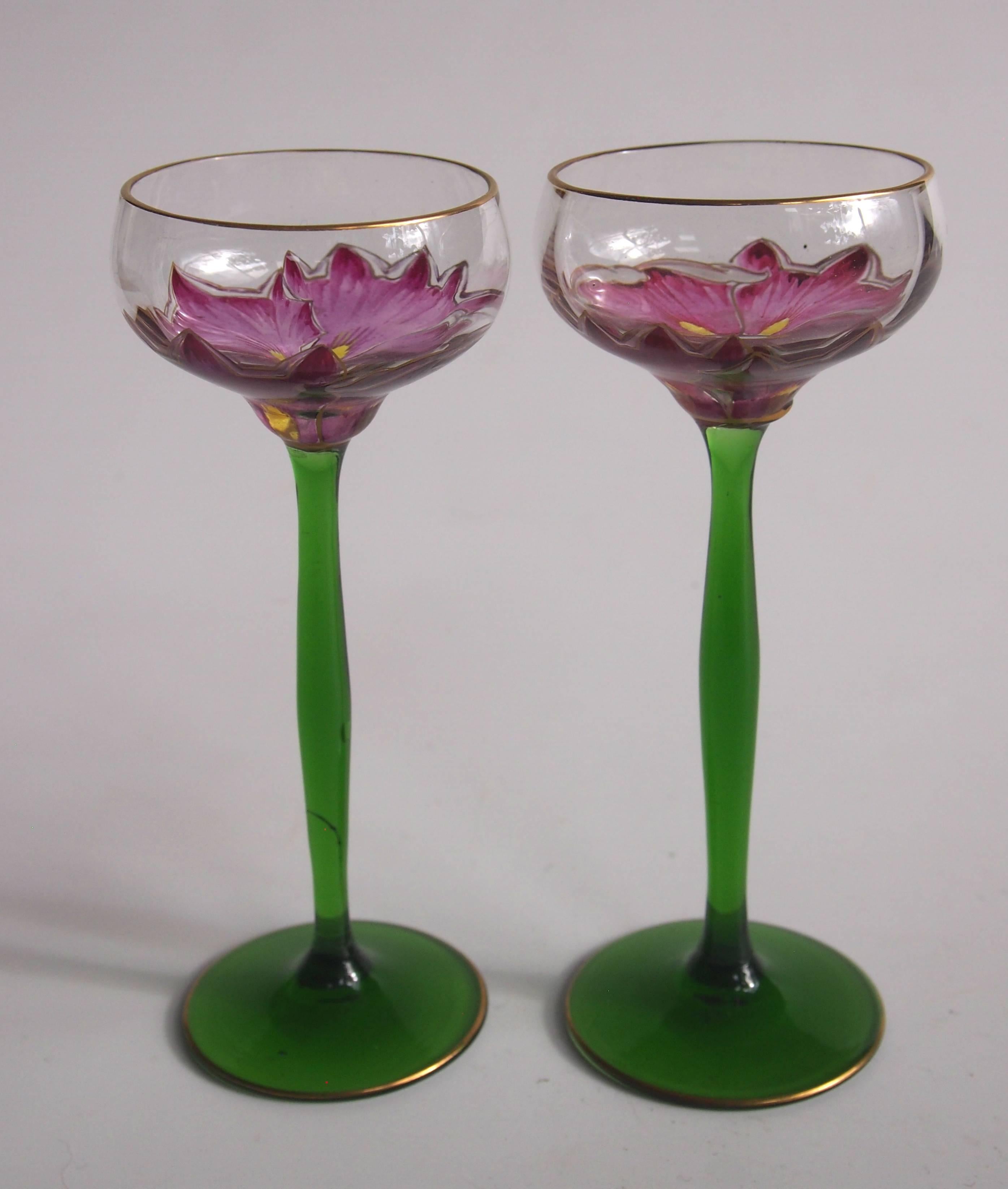Super pair of Art Nouveau gilded, green stemmed and enamelled, Meyr's Neffe 'Flower' glasses. They are enamelled with an open flower around the bowl so only when you drink from them do you get the full effect of the flower. 

'Flower' glasses were