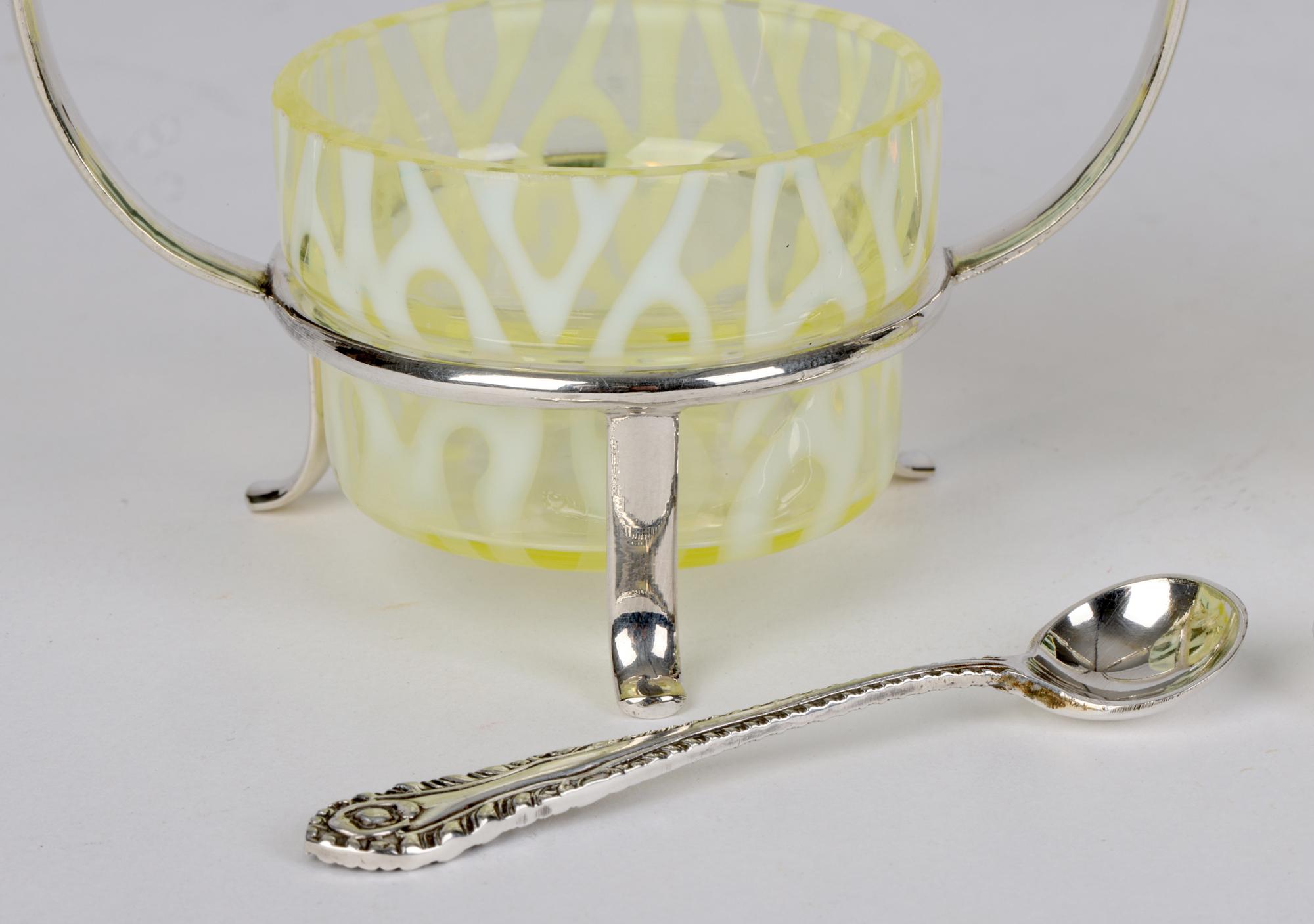 A stunning pair Art Nouveau silver plated open salts with original Powell opalescent glass liners by Michael Hunter & Son of Sheffield and dating from around 1900. The uranium yellow glass salts sit within a silver-plated frame mounted on three legs