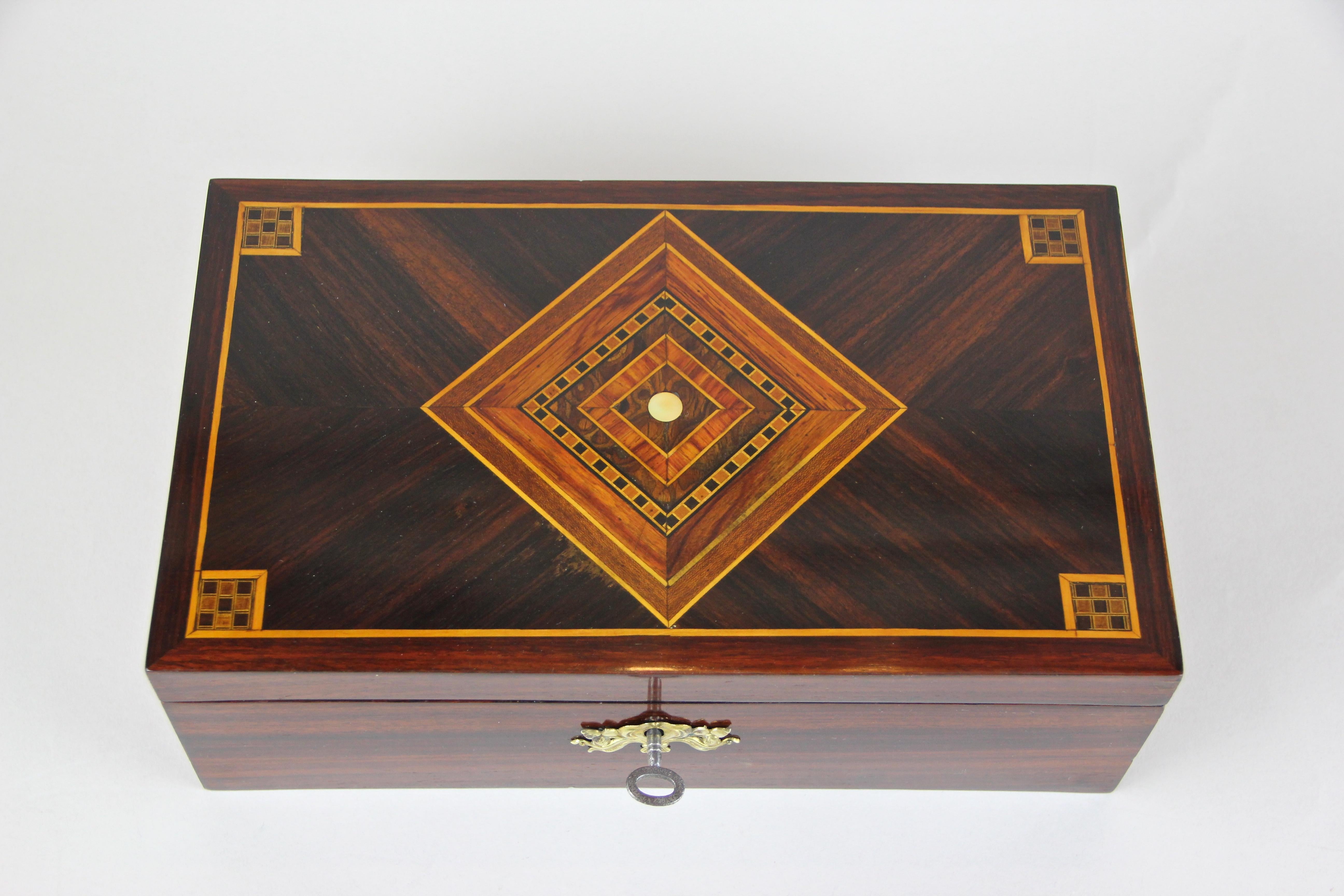 Elaborate made Art Nouveau Palisander box with inlay works from Austria, circa 1910.
Another highly decorative piece in our wooden box collection, veneered in finest palisander. By showing an absolute gorgeous inlayed design on the top of the lid,