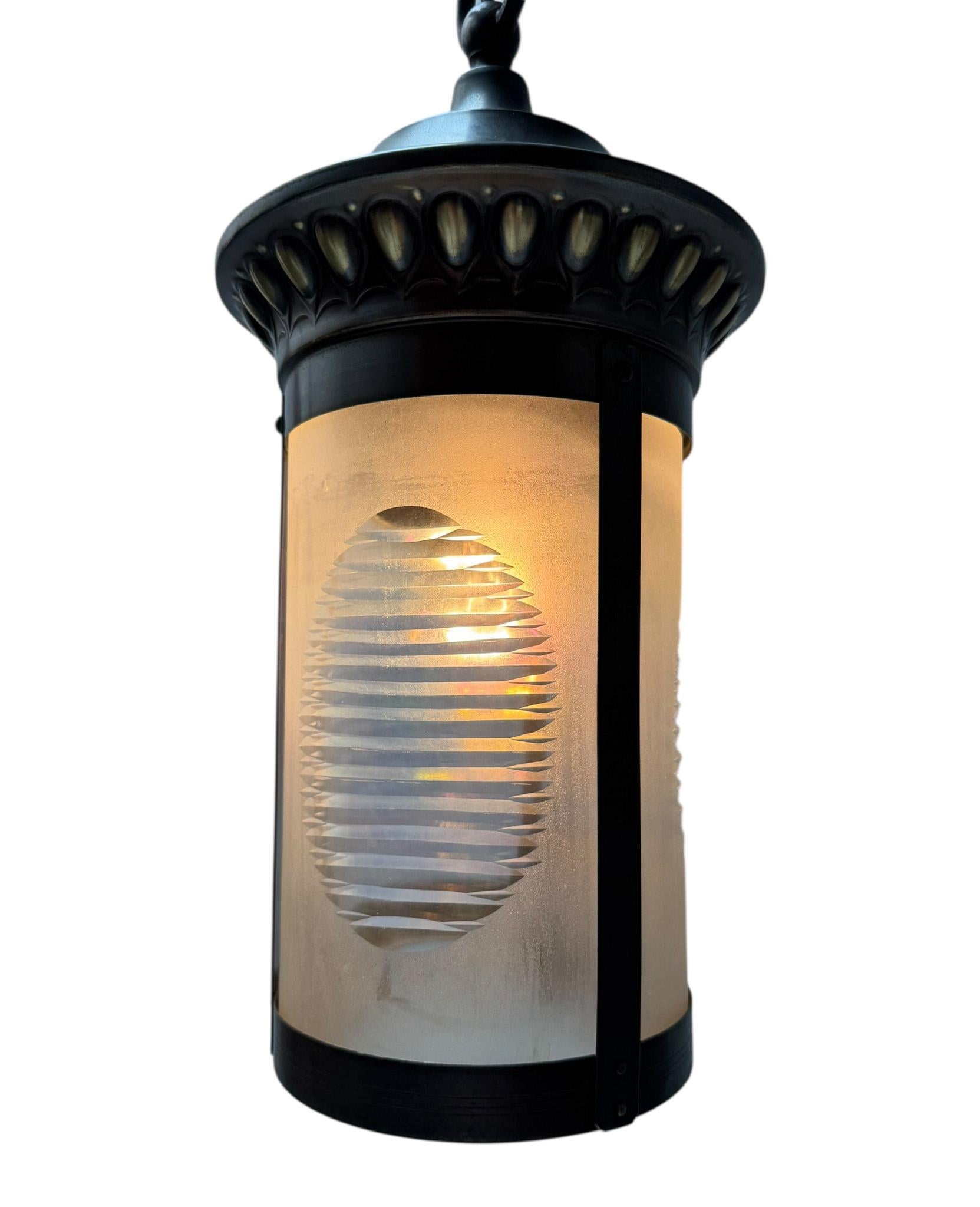Stunning and elegant Art Nouveau lantern.
Striking Dutch design from the 1900s.
Original patinated brass frame, chain and ceiling top.
The etched glass shade is also original.
Rewired with one original socket for E-27 light bulb.
This wonderful Art