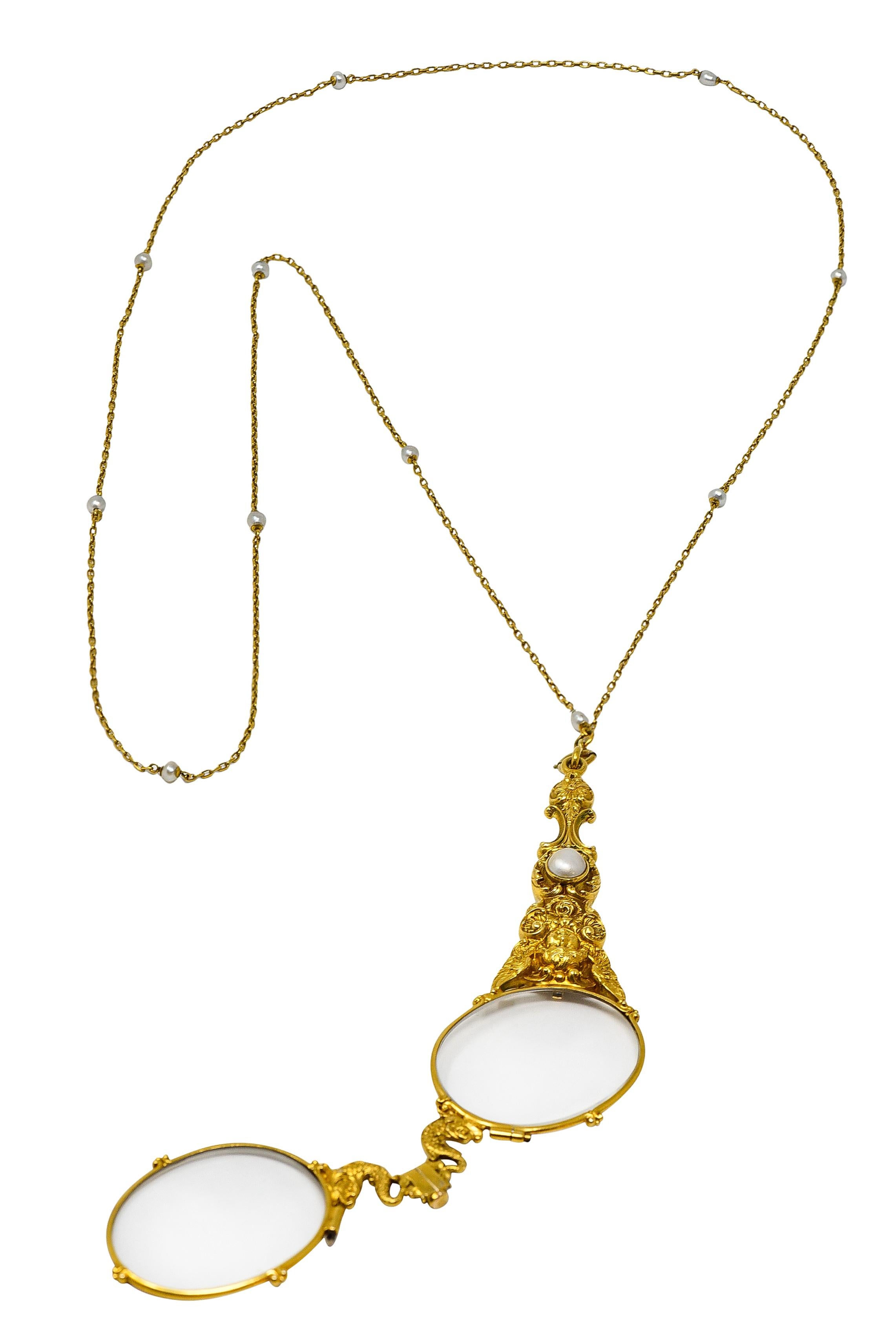 Long cable eternity chain necklace is intermittent with 3.0 mm pearl stations - white and iridescent. Suspending folded lorgnette glasses with a highly rendered handle. Depicting florals, cupids, and a cartouche centering a 6.5 mm mabe pearl. Cream