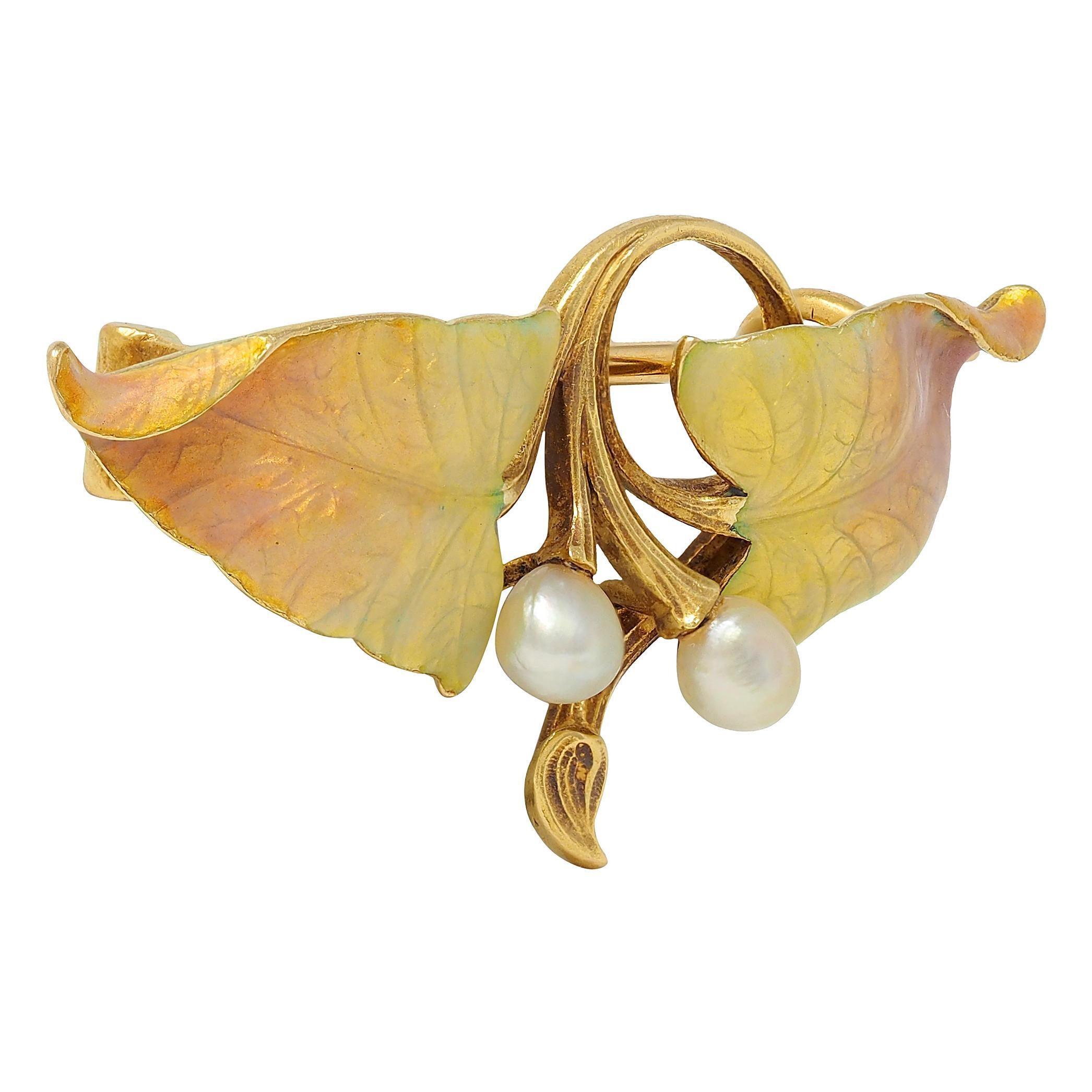 Designed as two dimensionally furling leaves connected via scrolling stems
Engraved with texture and veining glossed with basse-taille enamel
Transparent iridescent yellow to peach ombre - minimal loss
Accented by two baroque pearls mounted on end