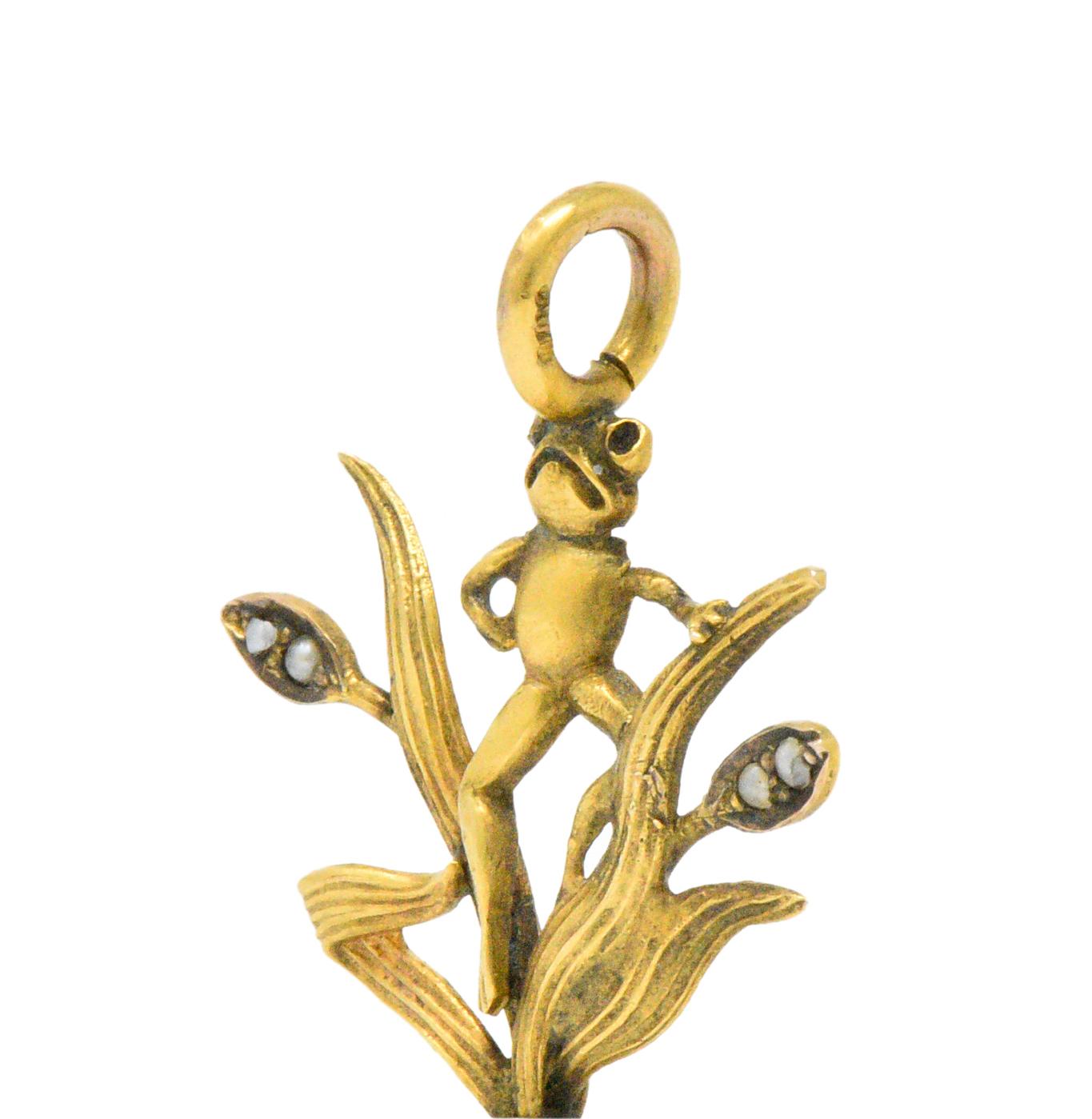 Designed as a cheeky little frog among the long flowing leaves and buds accented with tiny seed pearls, wonderfully detailed

On top of a freshwater natural baroque pearl, white with good luster and a little orient

His pose and stance says it all,