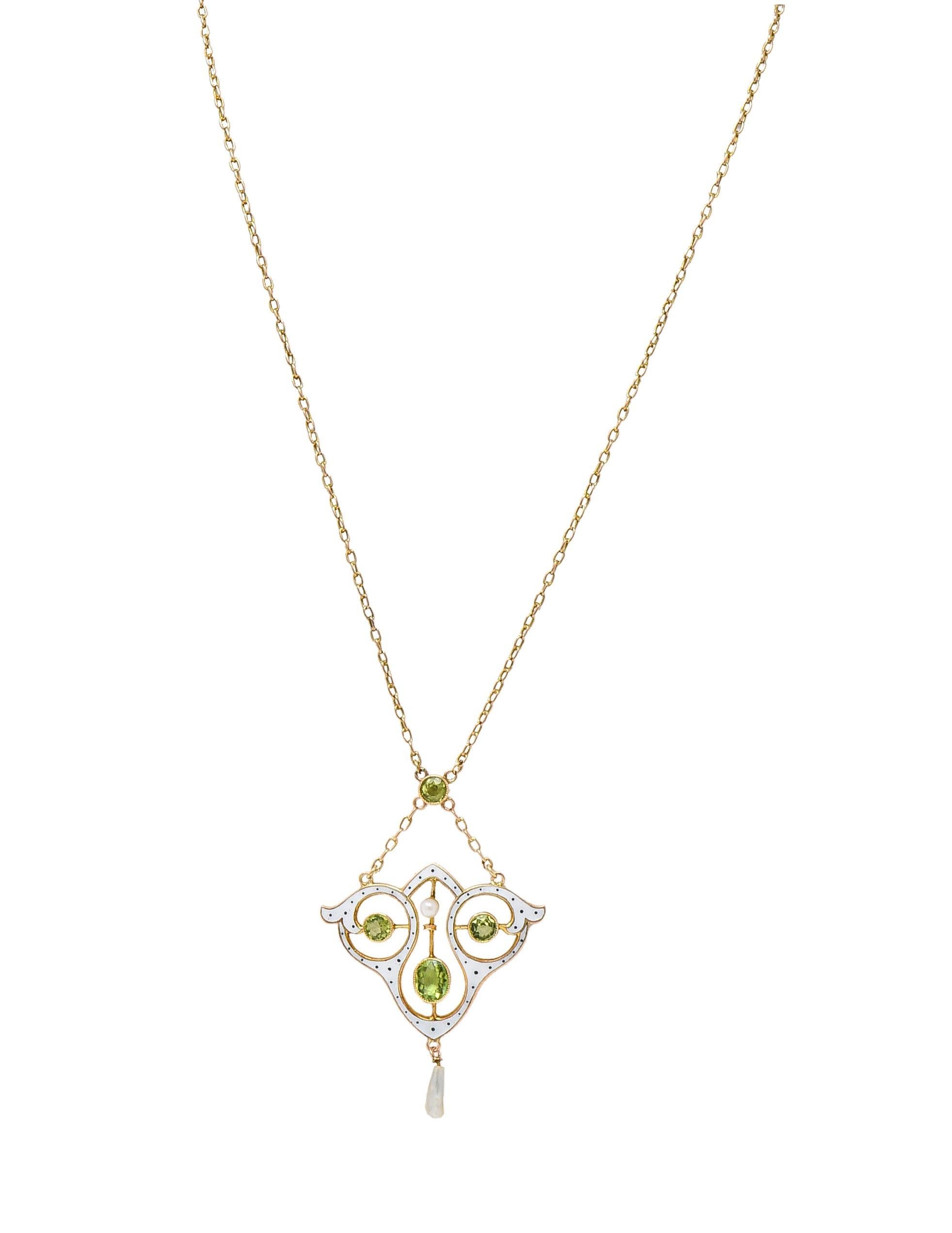 Designed as a cable link chain centering a lavalier-style surmount and drop pendant 
Featuring round and oval cut peridot bezel set throughout 
Transparent light green and weighing approximately 1.82 carats total
With a pierced whiplash motif