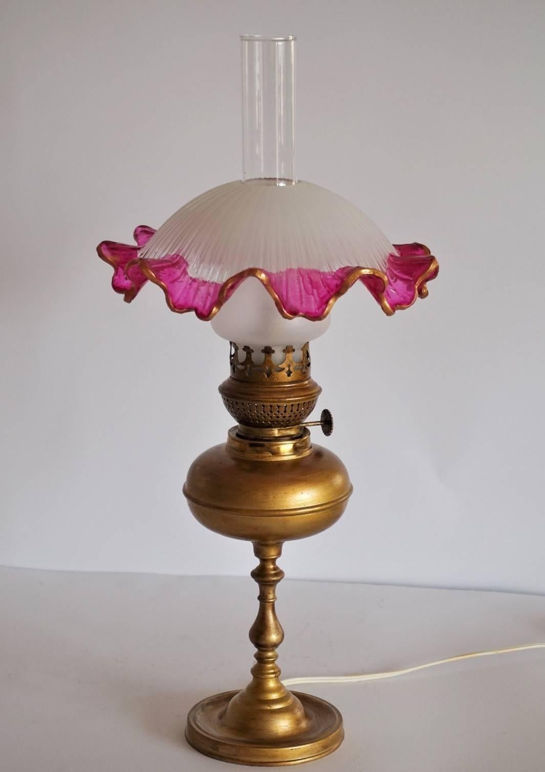 A lovely Art Nouveau oil lamp converted to electric, brass and a beautiful etched glass shade and hurricane chimney.
One E14 bulb light socket.
Measures: 
Height 19.25 in (49 cm)
Diameter 9.15 in (23 cm).