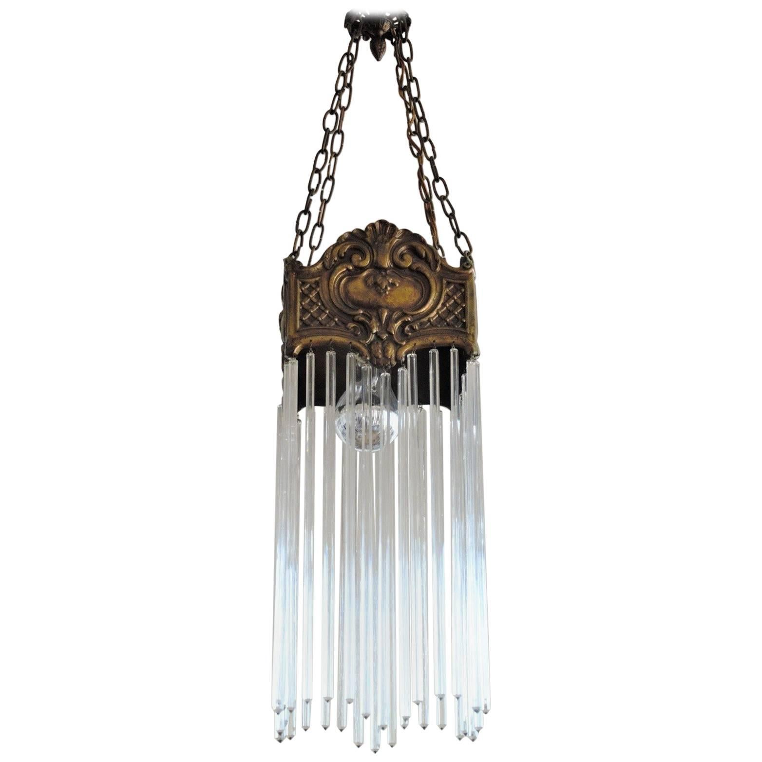 Art Nouveau period solid bronze with long faceted crystal rods pendant, France, early 20th century.
Very good condition, bronze with beautiful patina.

Measures: Total height 37 in (94 cm) 
Width/depth: 7.50 in (19 cm)
One large size bulb