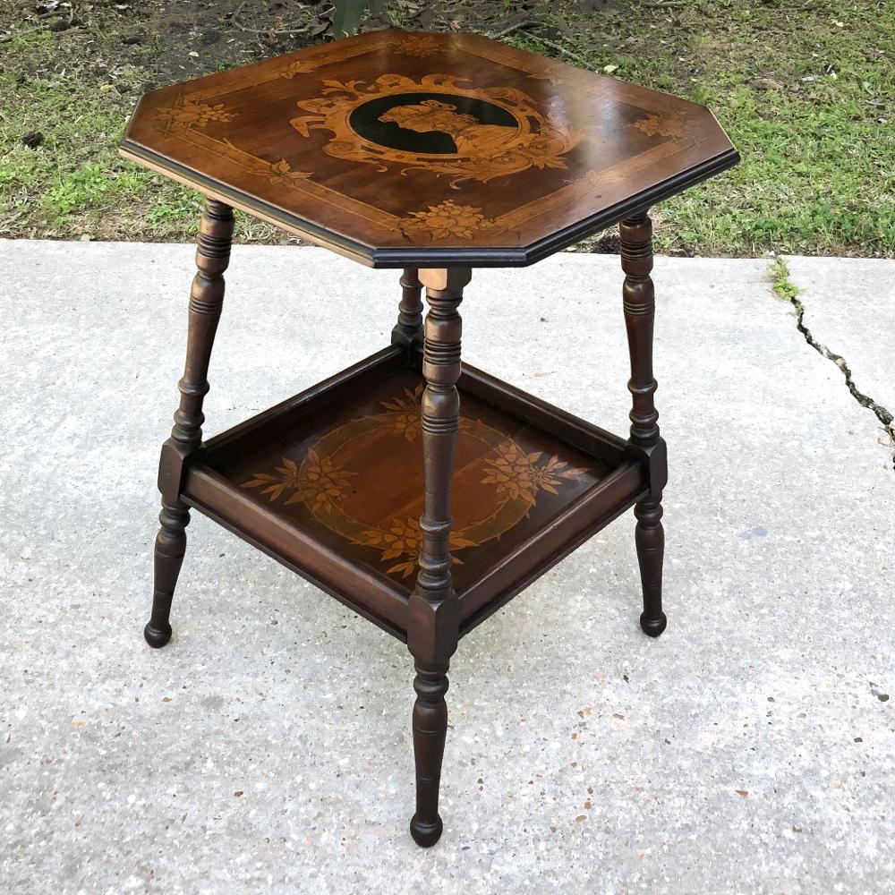 Art Nouveau period French marquetry end table is a masterwork of the furniture maker's art. Octagonal top is exquisitely inlaid with ebony, satinwood and mahogany to create a cameo-style profile of a beautiful maiden. The detailing around the