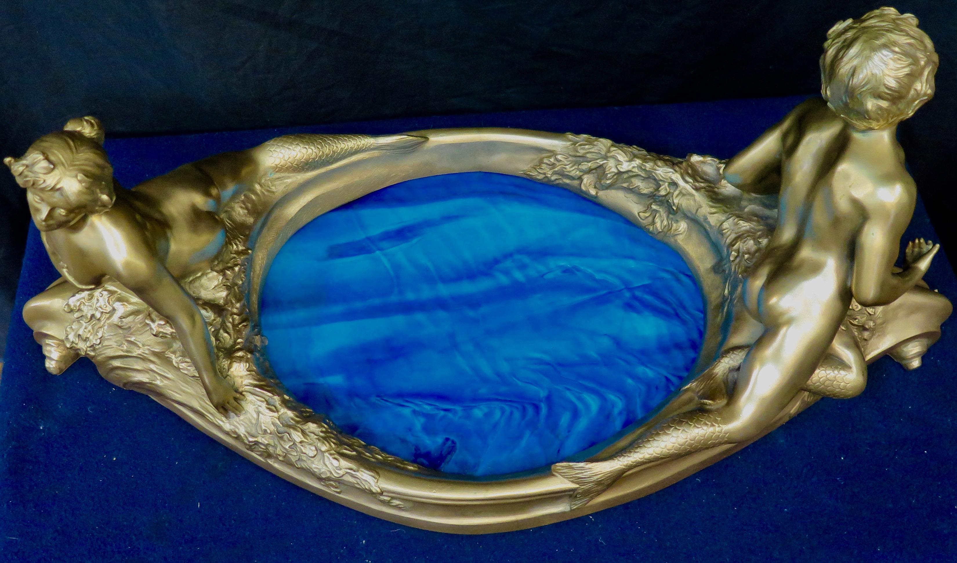This vintage Art Nouveau doré bronze French centerpiece features a pair of stunning mythological nude figures positioned on either end of an oval POOL designed in blue ripple art glass. The nude man & woman are exceptionally well detailed & adorned