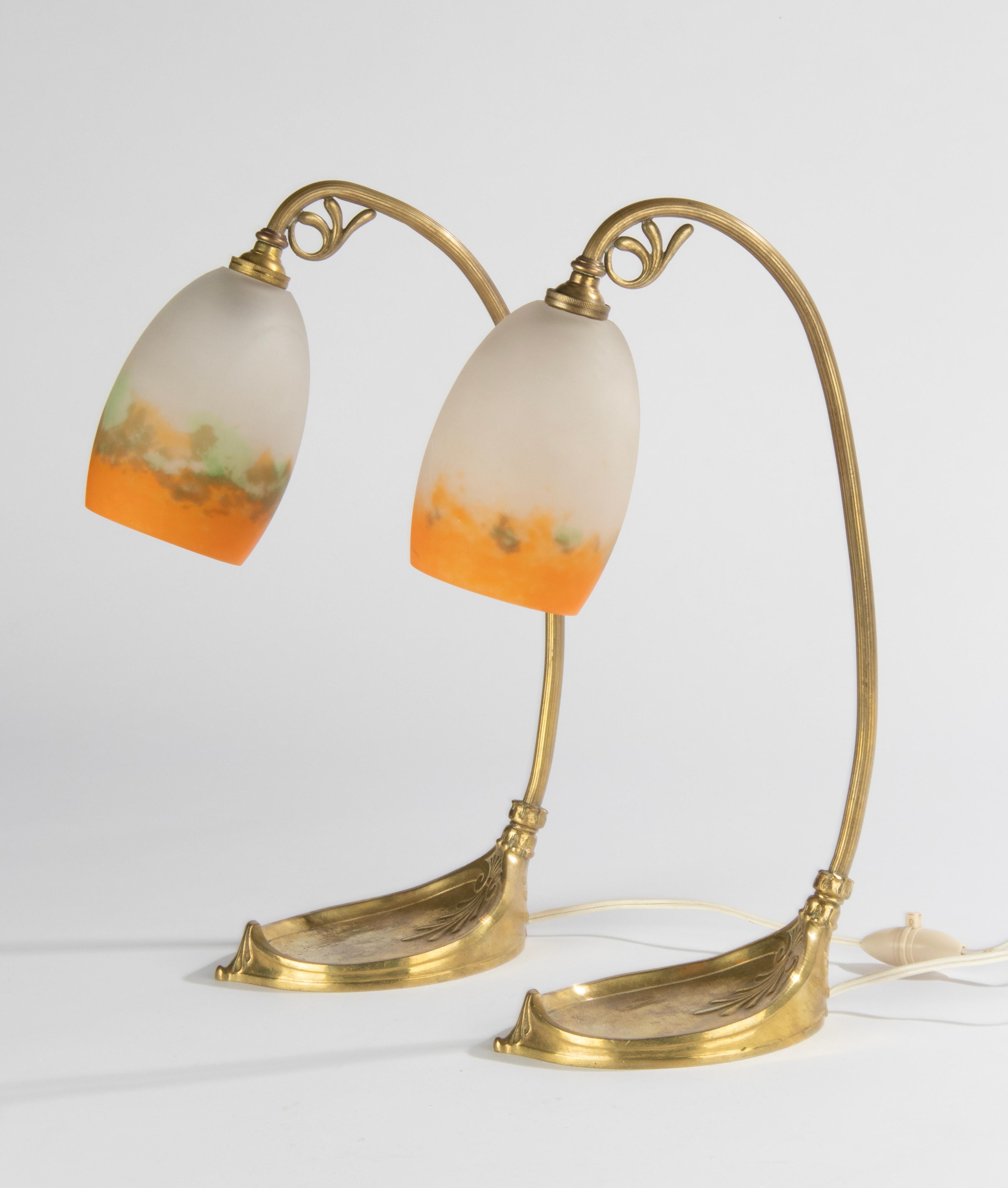 A pair of Muller table lamps from the French Art Nouveau period. The base is made of gilded bronze/brass. The lamps have pasta glass (pate de verre) lampshades, made and signed by Muller Frères from France. The glass has very nice bright green and