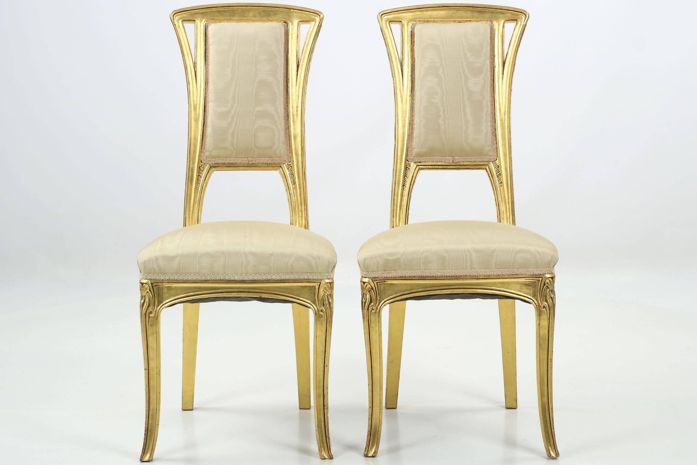 A perfectly designed and proportioned pair of giltwood side chairs that own the essence of the organic Art Nouveau form, they exhibit precise and gorgeous craftsmanship throughout their remarkably heavy frames. The design is loosely inspired by the