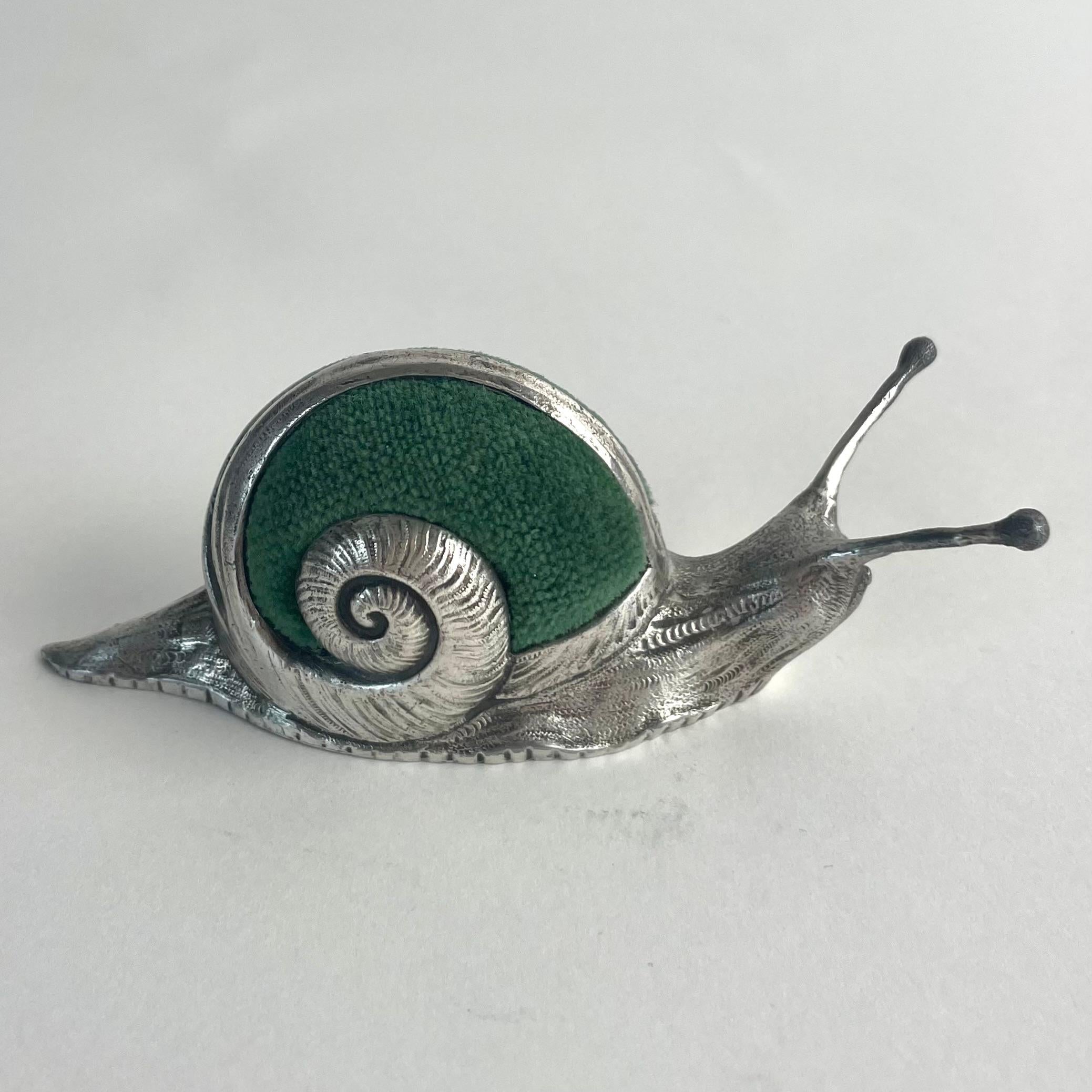 
Art Nouveau Pewter and Velvet Snail-Shaped Pincushion, Early 1900s

A charming and decorative snail-shaped pincushion in polished pewter with a green velvet cushion. The detailed craftsmanship and playful design are characteristic of the Art