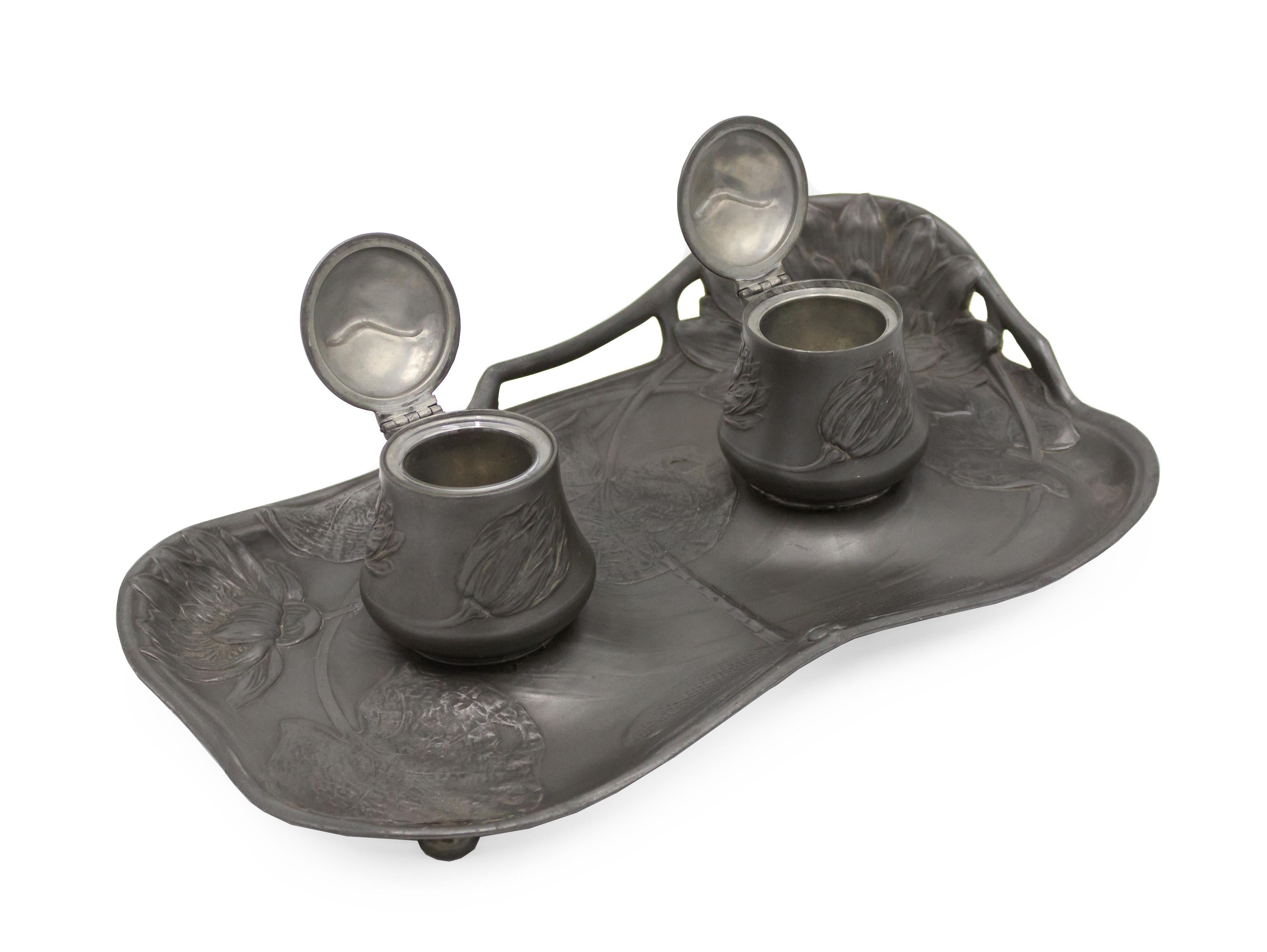 Art Nouveau rectangular pewter double inkwell with floral design and shaped gallery corners (Kayserginn).
  