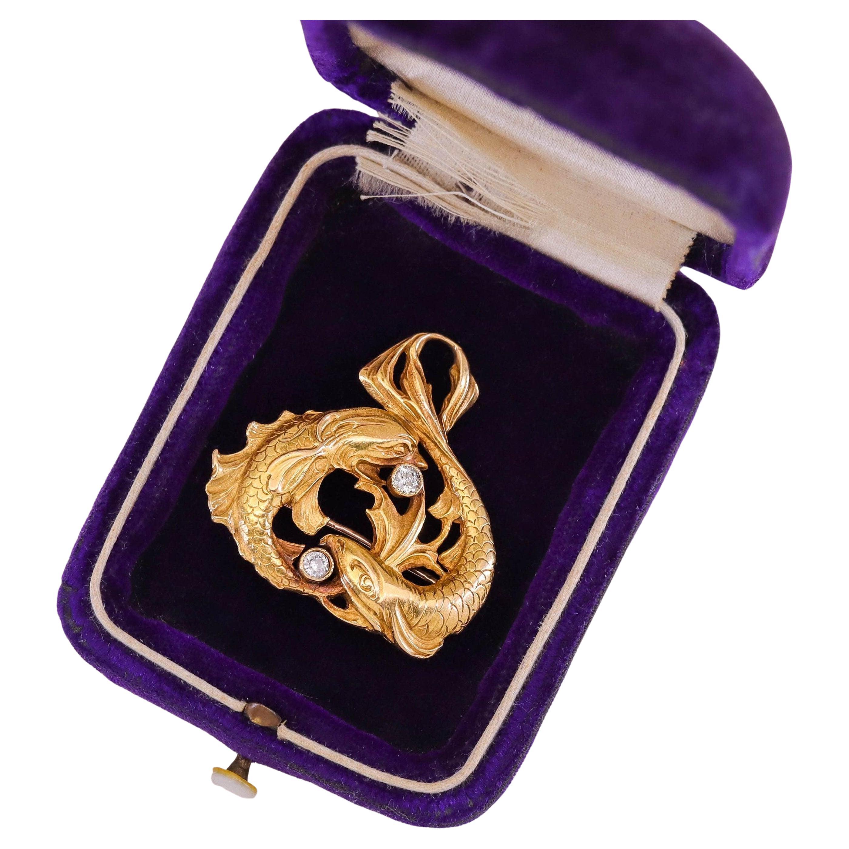 This antique 18k gold brooch (circa 1900) features a pair of koi fish accented with old European cut diamonds.

The piece can be worn either as a brooch or pendant. It measures 1.3 inches from the top to bottom by 1.3 inches wide. It weighs 16.86