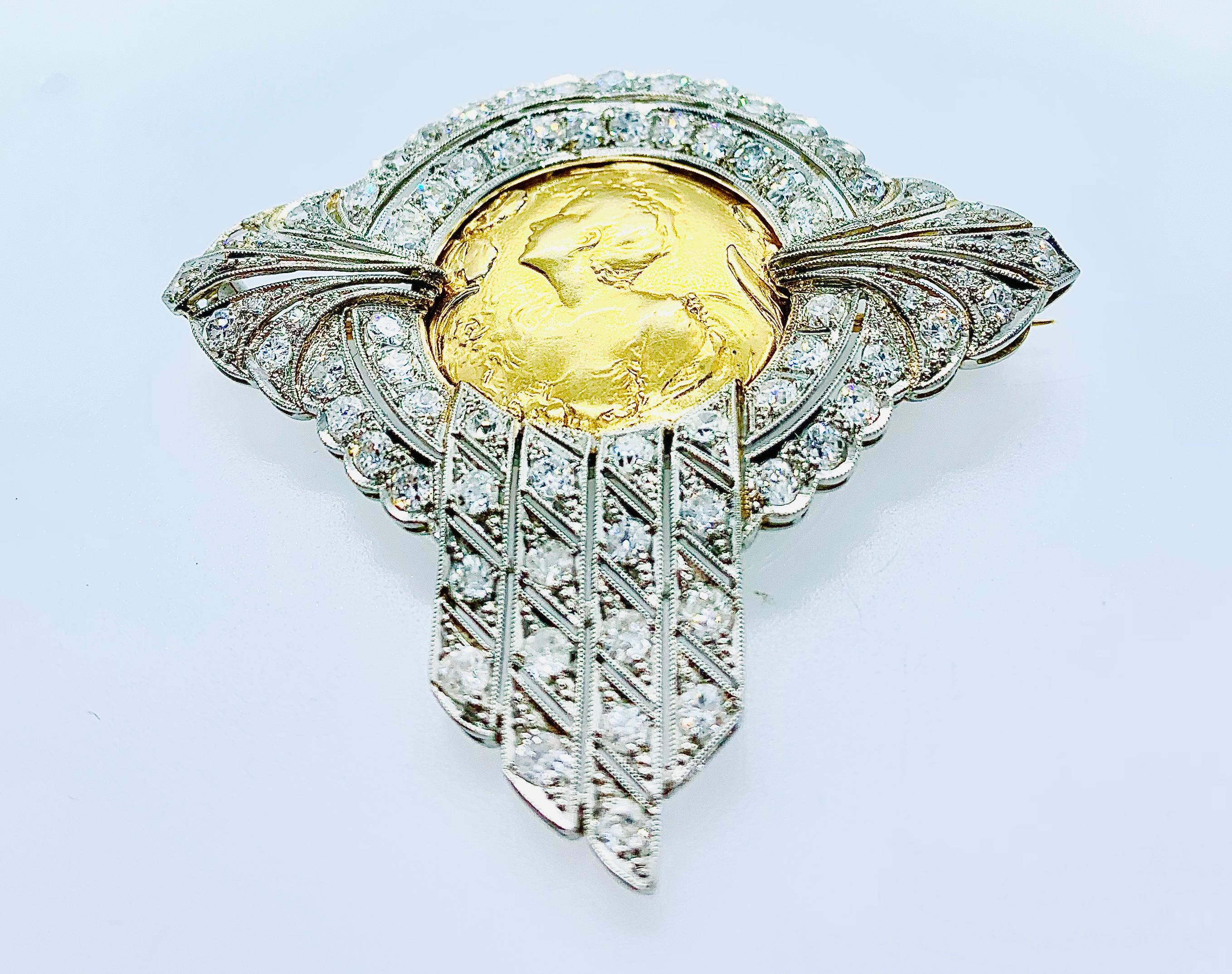 This is an absolutely stunning piece! This art nouveau brooch is made in Platinum with a round 18K Yellow gold center with a woman's figuring in bas relief. The brooch contains 76 mine cut diamonds with a carat total weight of 4.50 (estimated). The
