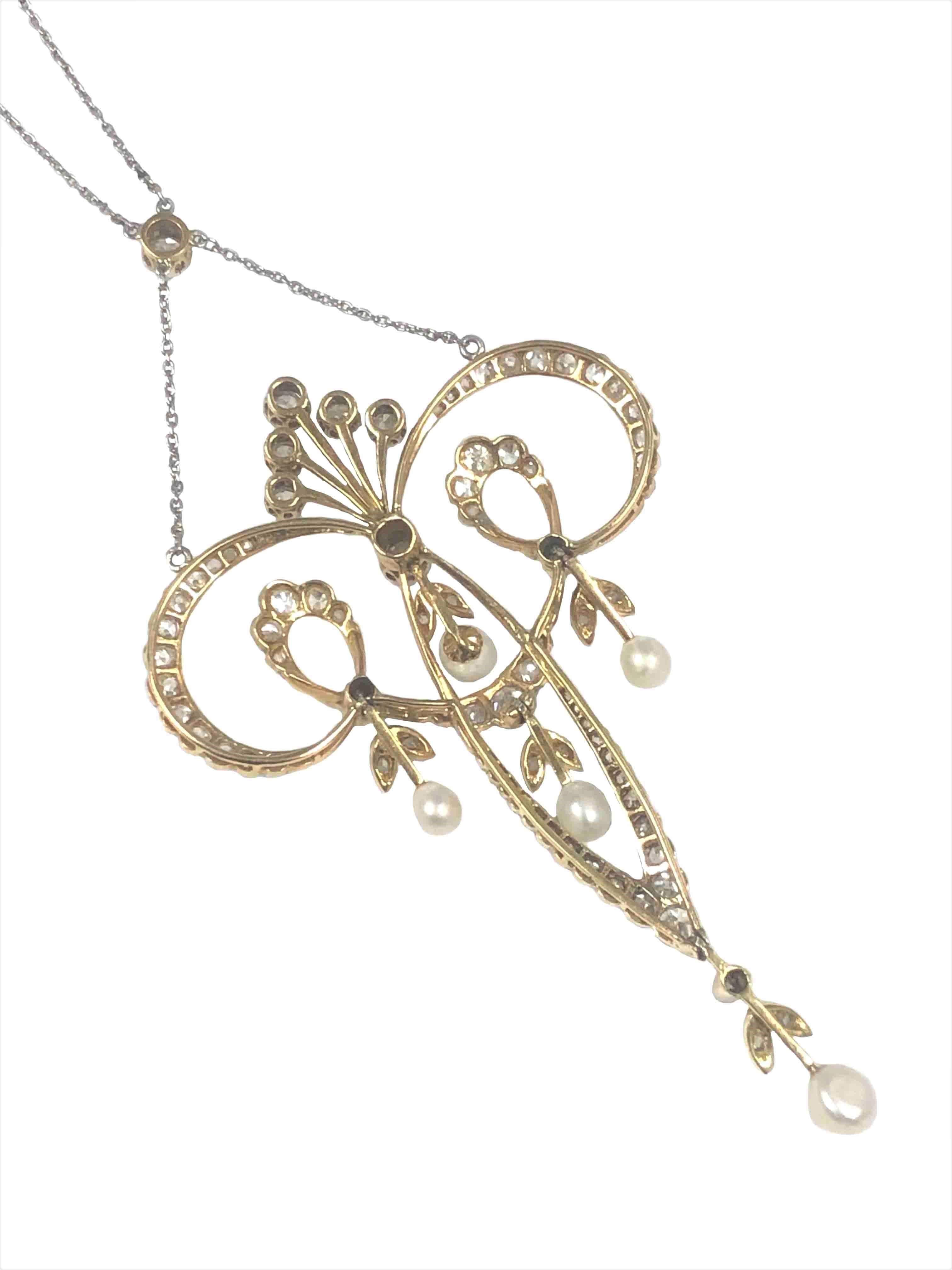 Circa 1910 Art Nouveau Platinum top and Yellow Gold backed Necklace, measuring 3 inches in length X 1 3/4 inches wide and suspended from a 17 inch chain. Set with European, Mine and Rose cut Diamonds totaling 2 Carats and further set with Natural