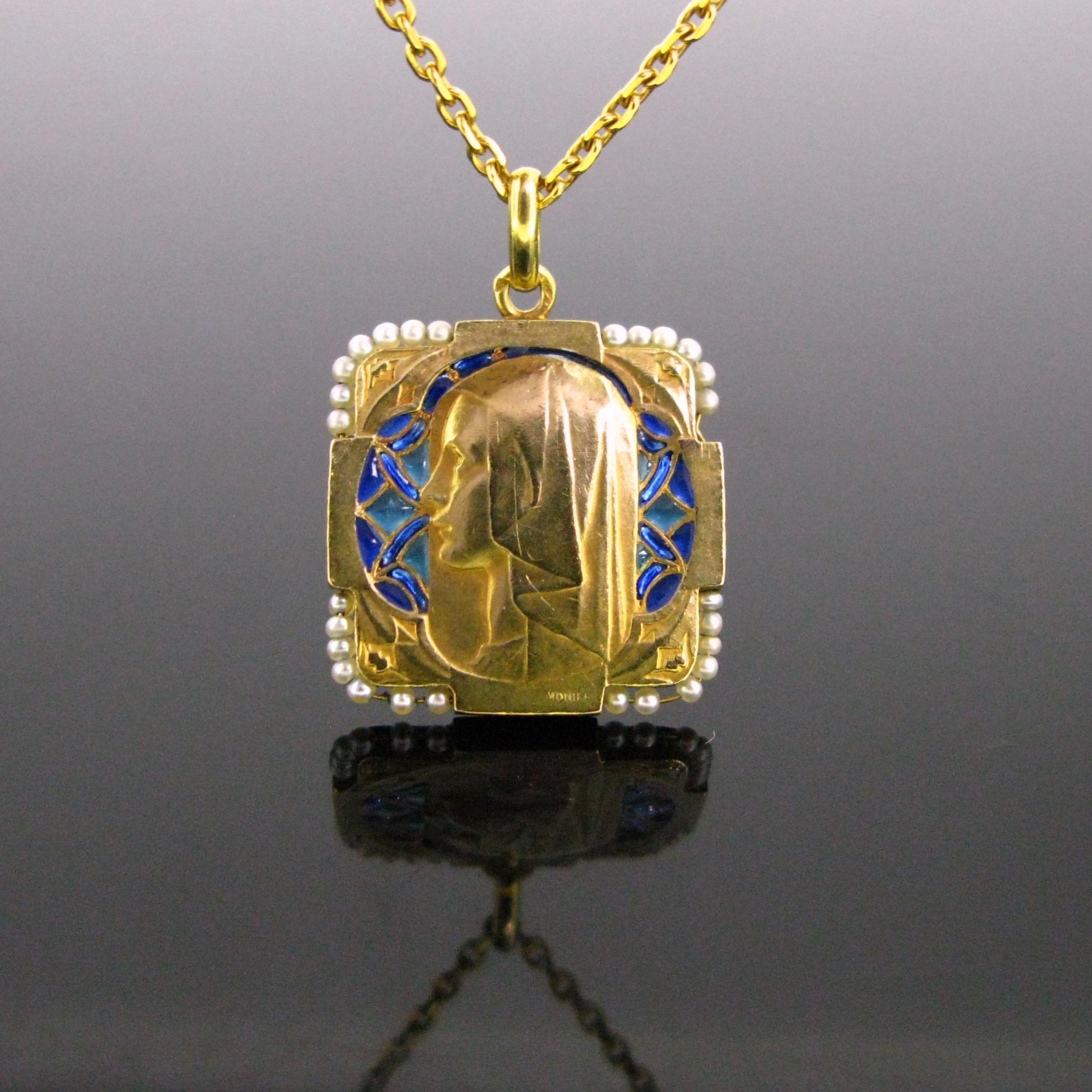 Heritagem presents:

This beautiful square shape medal, from the Art Nouveau period, is made in 18kt yellow gold with Plique à jour navy blue and green enamel. It features the profile a young saint looking to the left. The corners are nicely adorned