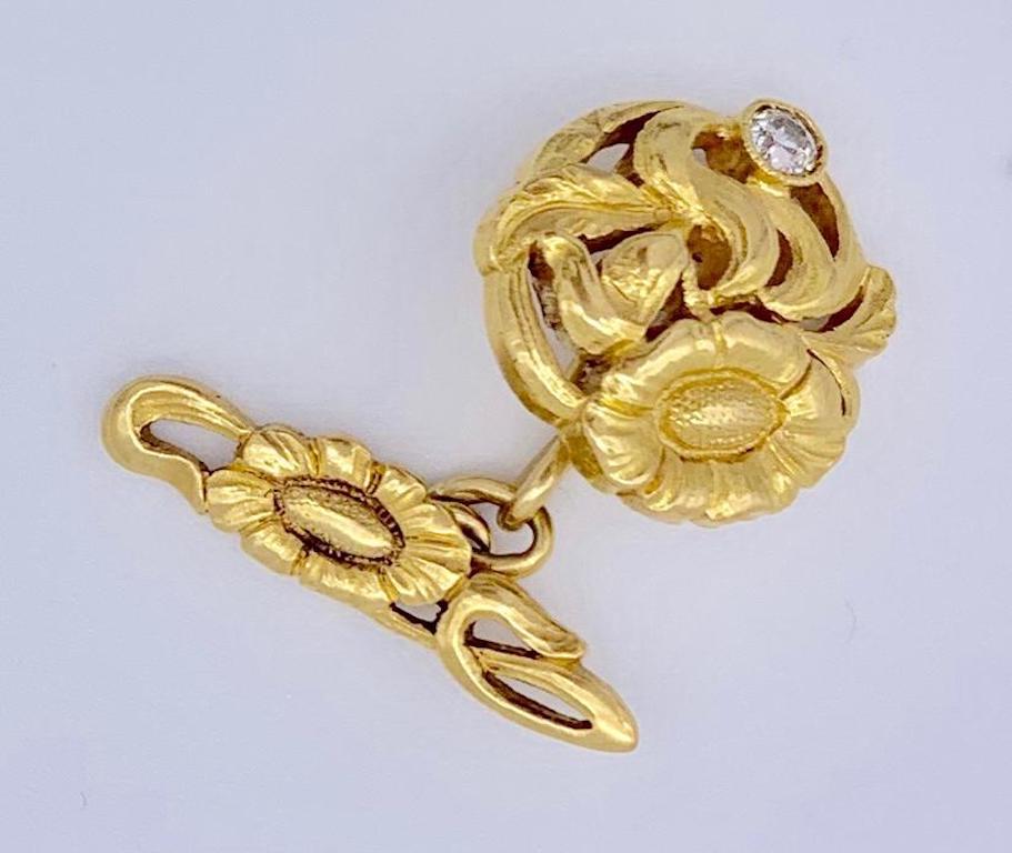 These exquisite beautifully designed Art Nouveau cufflinks have been executed around 1895-1900. The work has been executed in 18 k gold and decorated with old cut diamonds. The open work design is of poppy flowers surrounded by delicately arranged