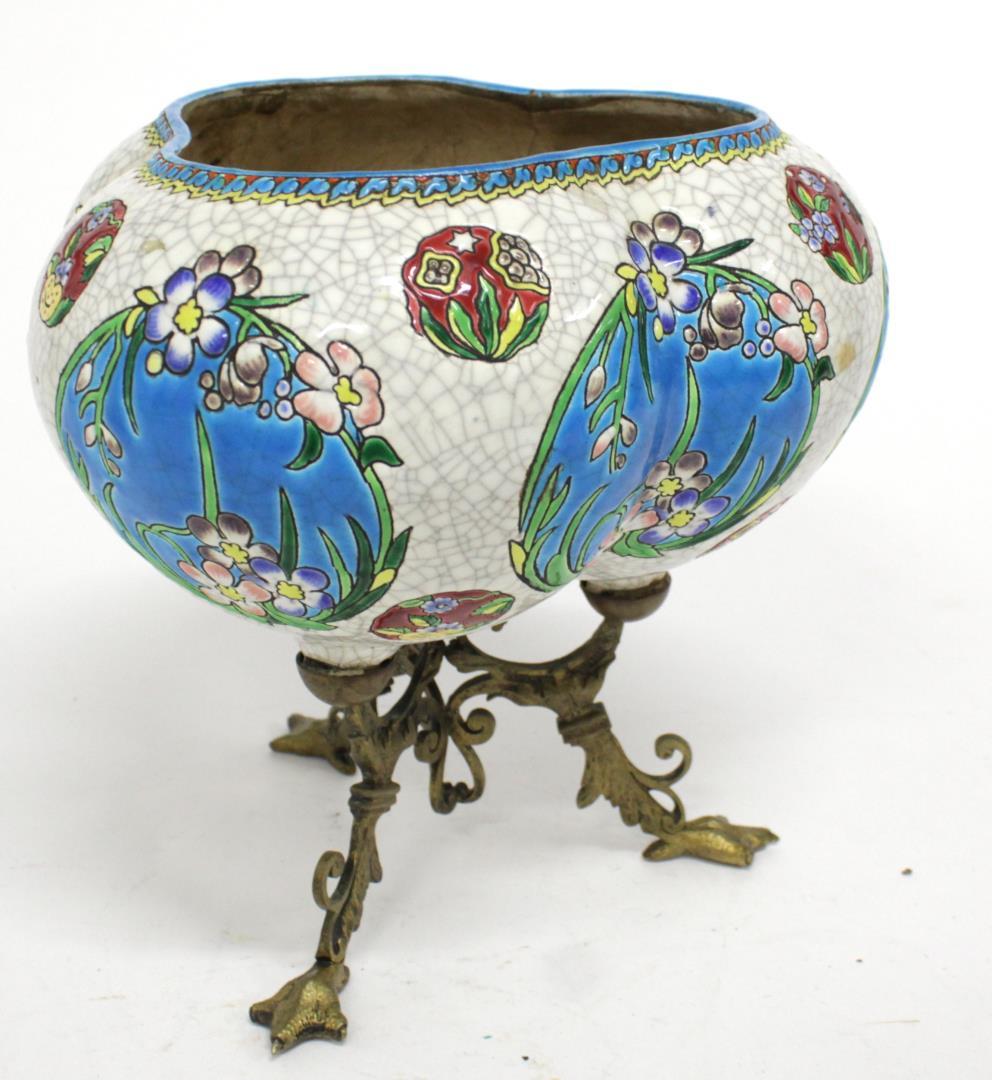 European Art Nouveau enameled porcelain vase on a brass tripod animal-paw support, designed in the style of Faience de Longwy. In great antique condition with age appropriate wear and some repairs surrounding leg-junctures, as well as a hairline