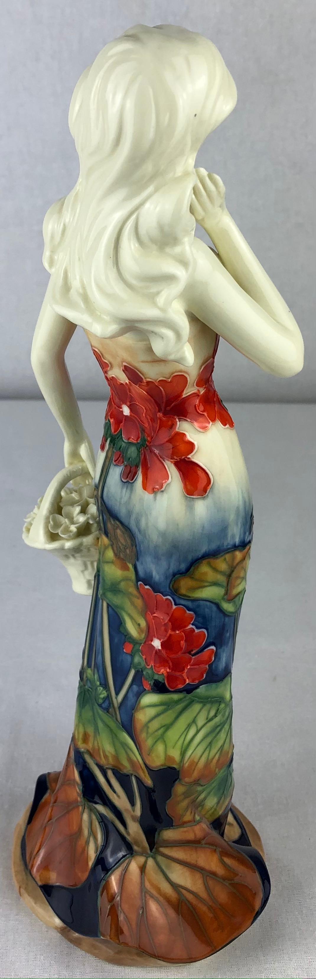 Beautiful hand painted Art Nouveau period porcelain of a woman with a bouquet of flowers. 

The decoration consists high relief designs and eye catching colors including blue, beige, red and green. 
Bears the makers mark, Decors du Galion.