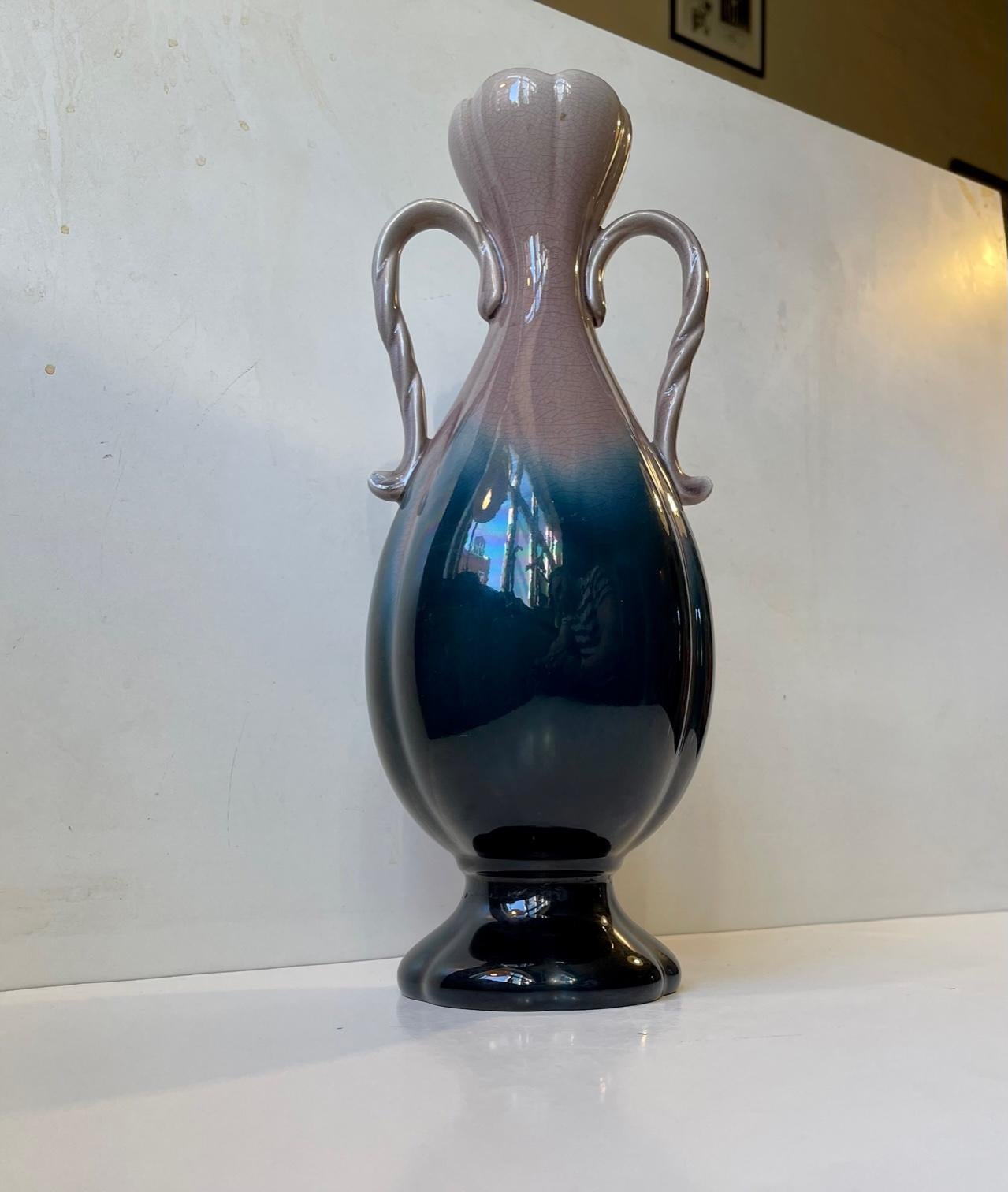 Large porcelain/creamware vase / urn made by Swedish porcelain gigant Rörstrand circa 1910. It has a grey/petrol blue glaze that fades from dark to light. The inside has a turquoise glaze. Measurements: H: 35 cm, D: 13/10 cm. Stamped Rörstrand to