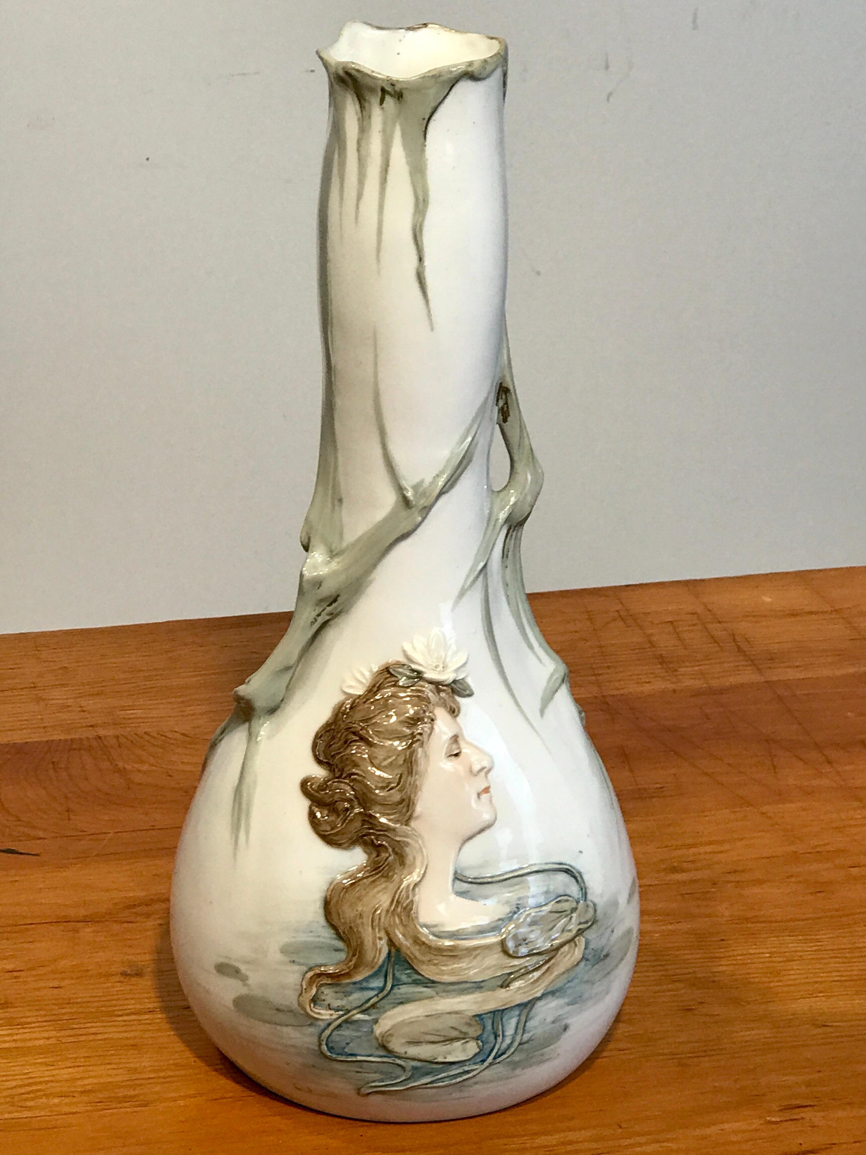 Art Nouveau Portrait Vase Attributed to Teplitz
Early 20th Century, Austria
Dimensions: Height: 14 in Width: 7 in )Depth: 7 in

Immerse yourself in the timeless charm of this Art Nouveau portrait vase, a creation marvelously attributed to Teplitz.