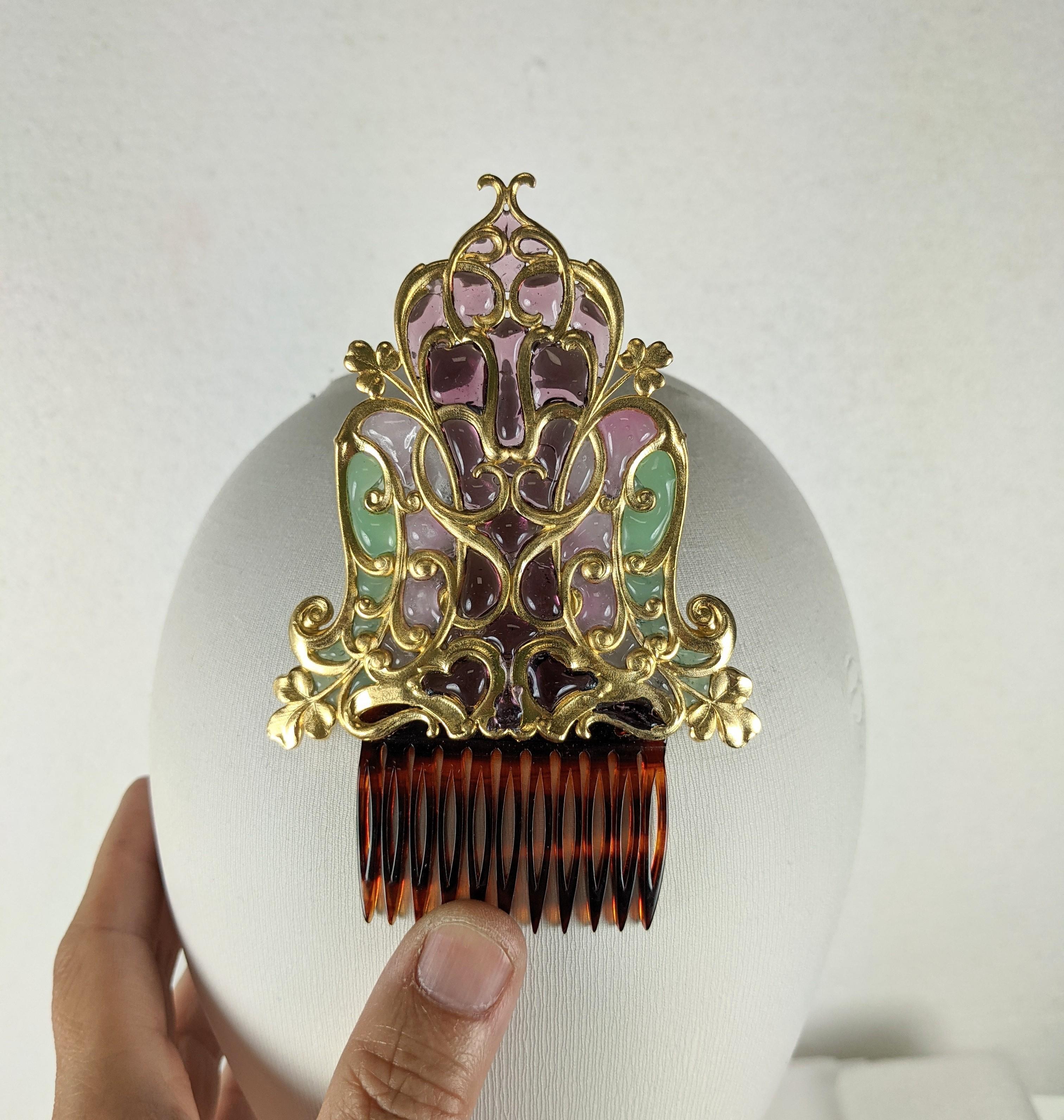 Art Nouveau Poured Glass Plique Comb from the 1900's. Large art Nouveau clover motif bronze frame with pate de verre enamel accents throughout. 
Designed to be worn high in the hair for the light to shine through the glass panels. 
1900 France.