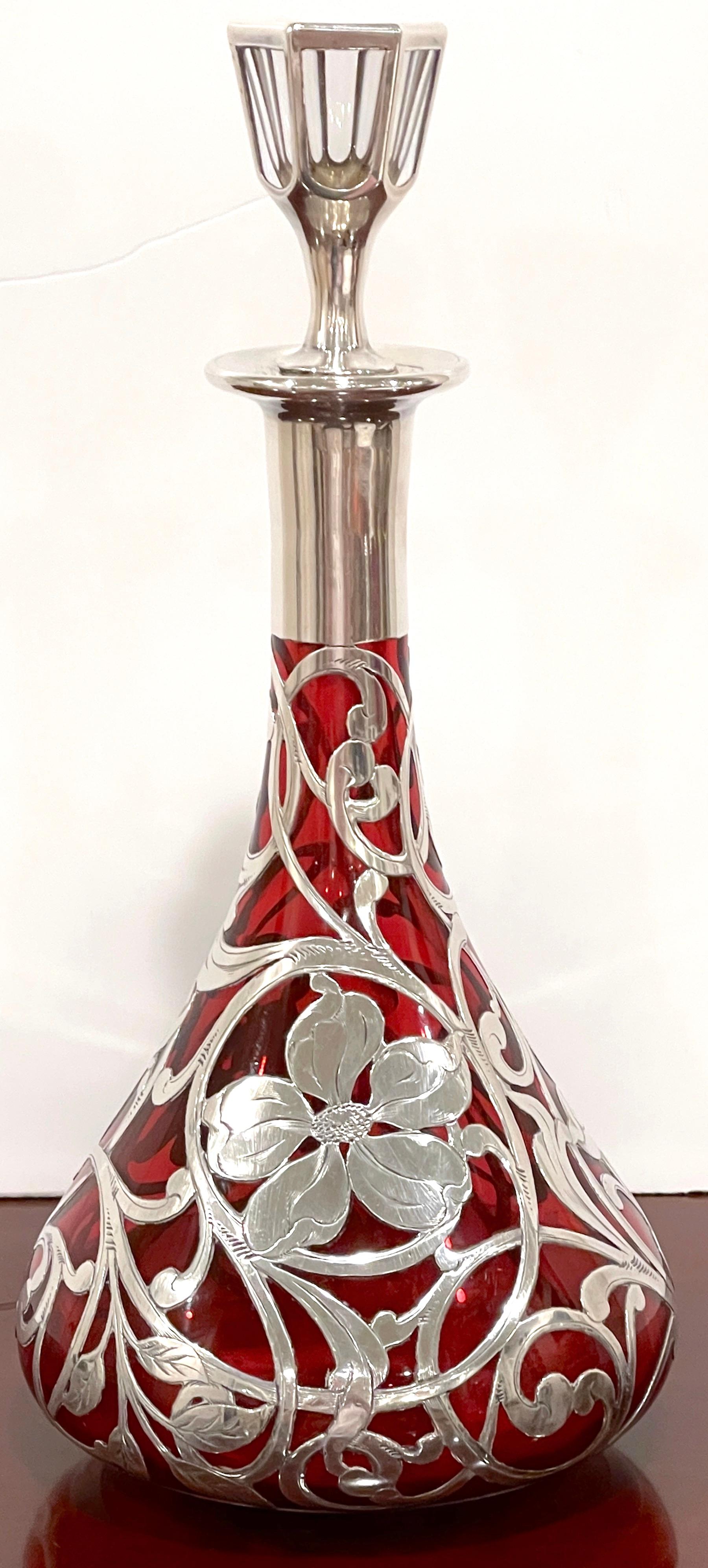 Art Nouveau red glass silver overlay decanter by La Pierre Silver Co. 
USA, Circa 1900s
A spectacular example of Art Nouveau design, Retains the orignal clear panel cur silver-overlay 4-inch decanter, resting on a tapering red cut crystal body