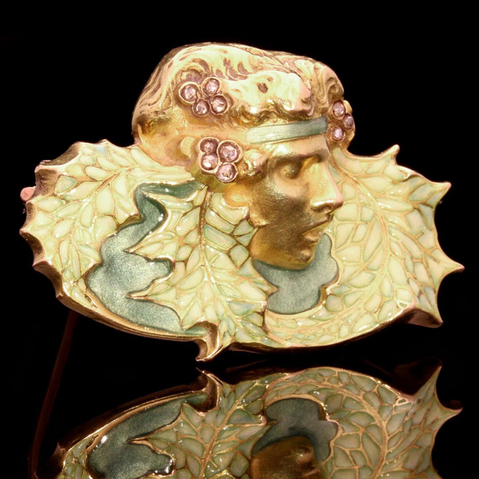 ART NOUVEAU GOLD, DIAMOND & ENAMEL BROOCH BY RENE LALIQUE c.1900
Modelled as the head of a woman 'wood nymph' with rose-cut diamond-set pale green translucent enamel bandeau surrounded by matching enamel stylised leaves, the reverse with pale green