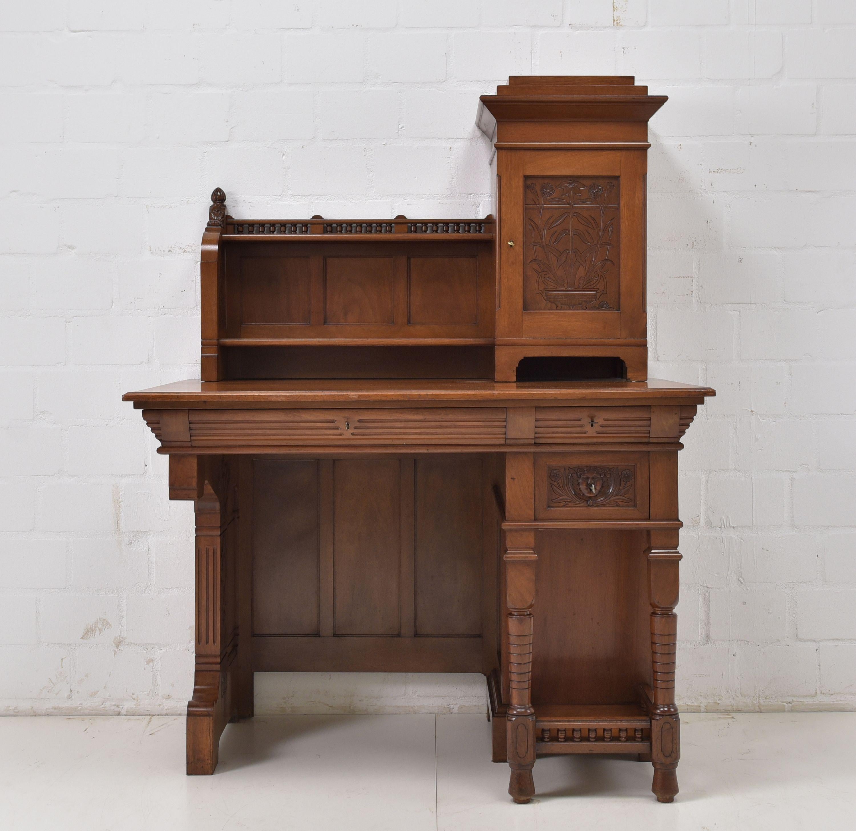 Restoration desk Art Nouveau walnut lady's desk

Features:
Asymmetrical model with two drawers and various compartments / doors
Very high quality processing
Heavy quality
Elaborately thought-out design
All drawers dovetailed
Beautiful carved