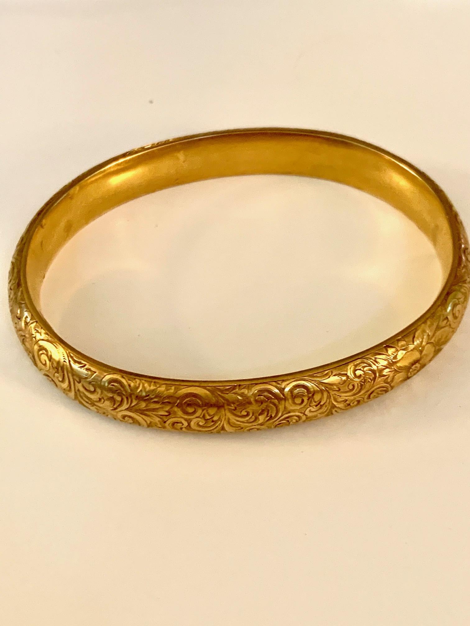 This beautiful Art Nouveau Riker Brother 14 kart yellow Gold bangle has amazing floral foliate design engraving throughout the entire bangle.  This piece is stamped 14k with a Riker hallmark. 
Measurement:
The outside circumfernce is 8 3/4