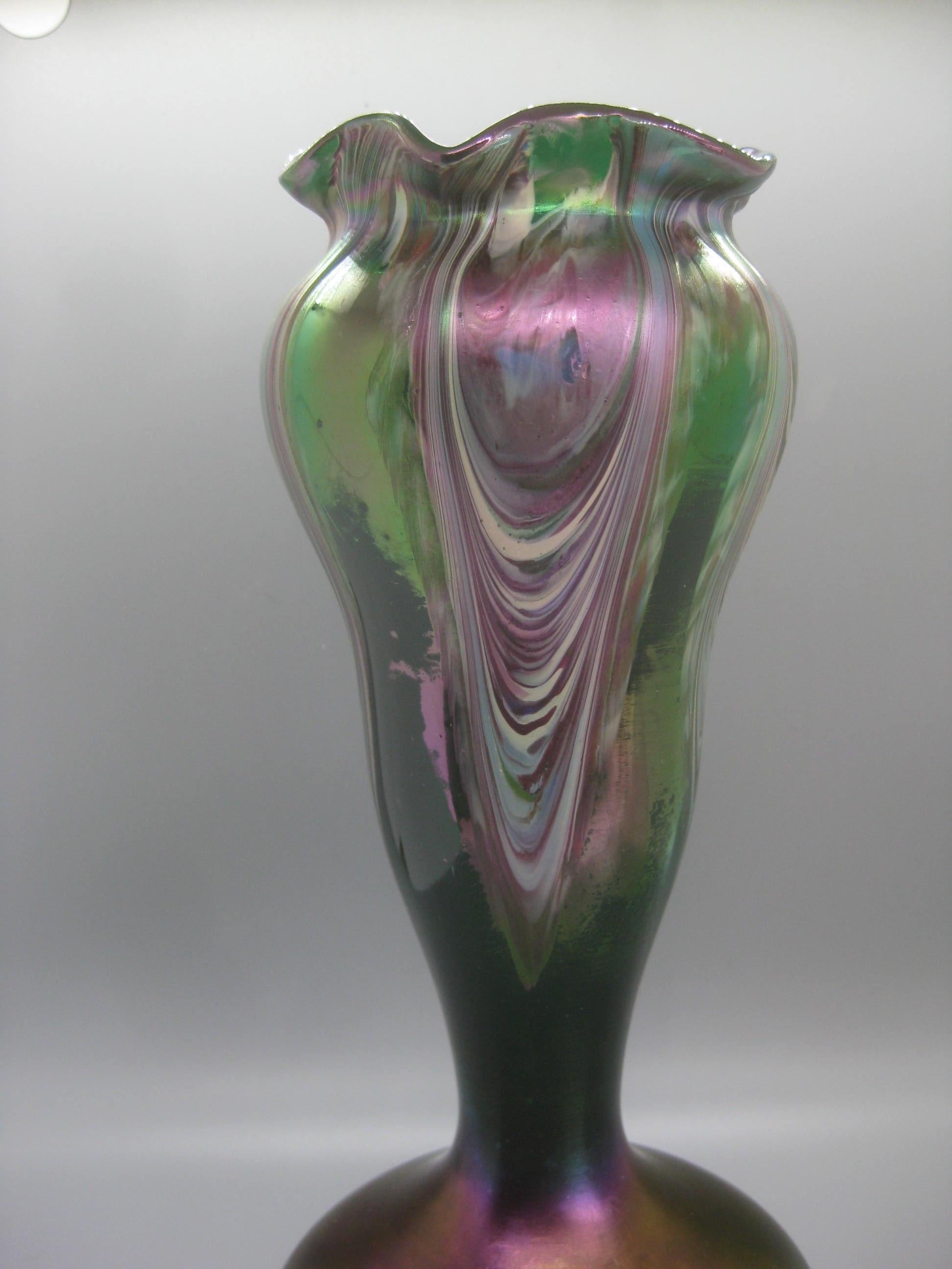 Stunning Art Nouveau Czech Bohemian iridescent pulled feather art glass vase by Josef Rindskopf, circa early 1900s. The vase has wonderful color and design. Green clear glass body with an opaque pulled feather design. Handmade and has a polished