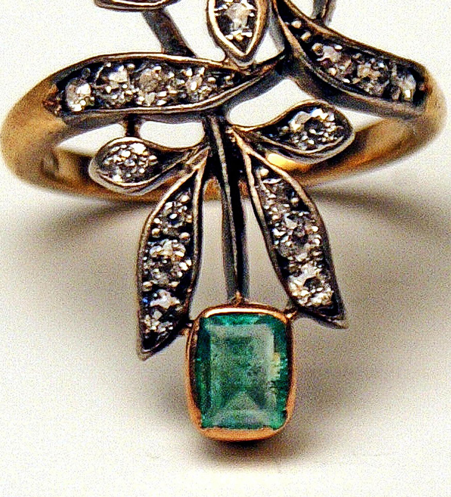 Golden Art Nouveau Ring of most elegant appearance with many diamonds attached in decorative manner so that impression of stylized leaves arises.   

GOLD  (14 ct  /  585)  /  DIAMONDS  (VINTAGE CUTS) / ONE EMERALD  & so-said SILBERFASSUNG  (=