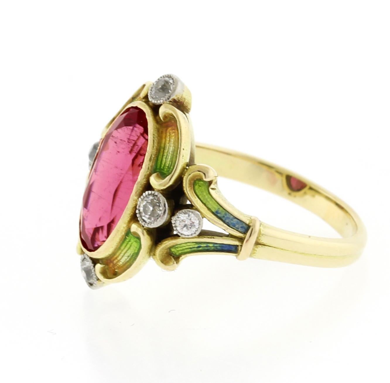 This 14kt yellow gold ring has orange, yellow, green and blue enamel.  
• Metal:14kt Yellow Gold
• Circa: 1890s
• Gemstone: Pink Tourmaline, 6 Diamonds
•Dimensions: Pink tourmaline- Approx. 11.1 x6.1 x4.25mm
• Size: 4.25
• Packaging: Pampillonia