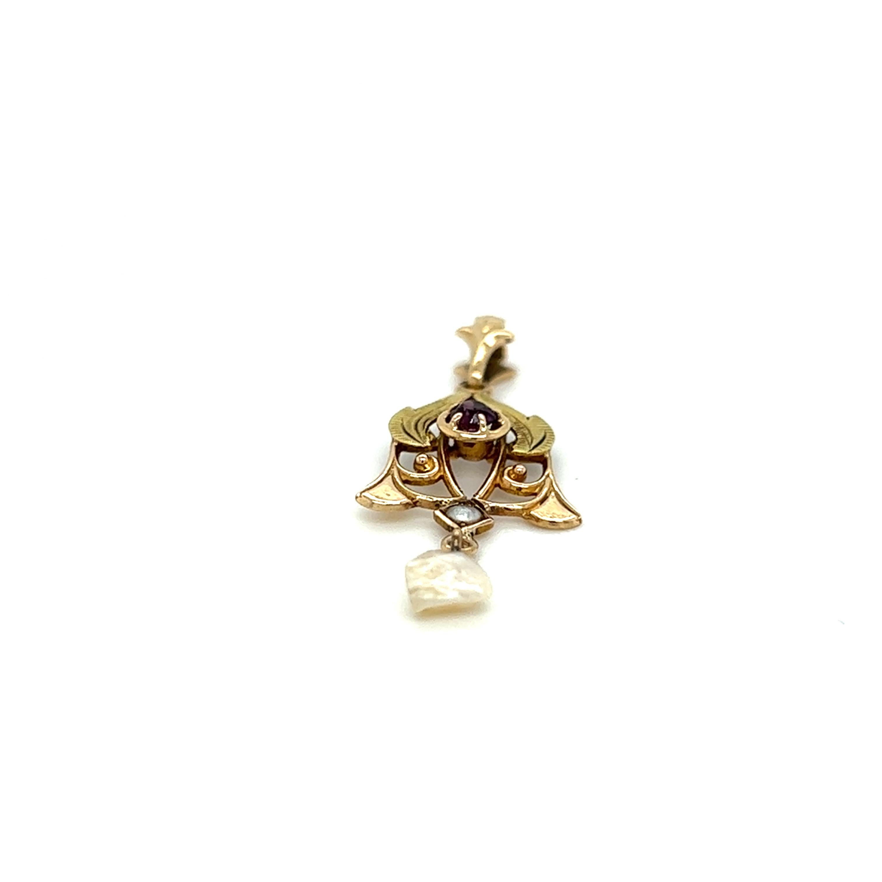 One 10 karat yellow gold Art Nouveau pendant, set with one 3mm round pink sapphire, one seed pearl, and one freshwater Mississippi river Pearl.  The pendant measures 1.25 inches long and weighs 0.9 grams total weight.  
