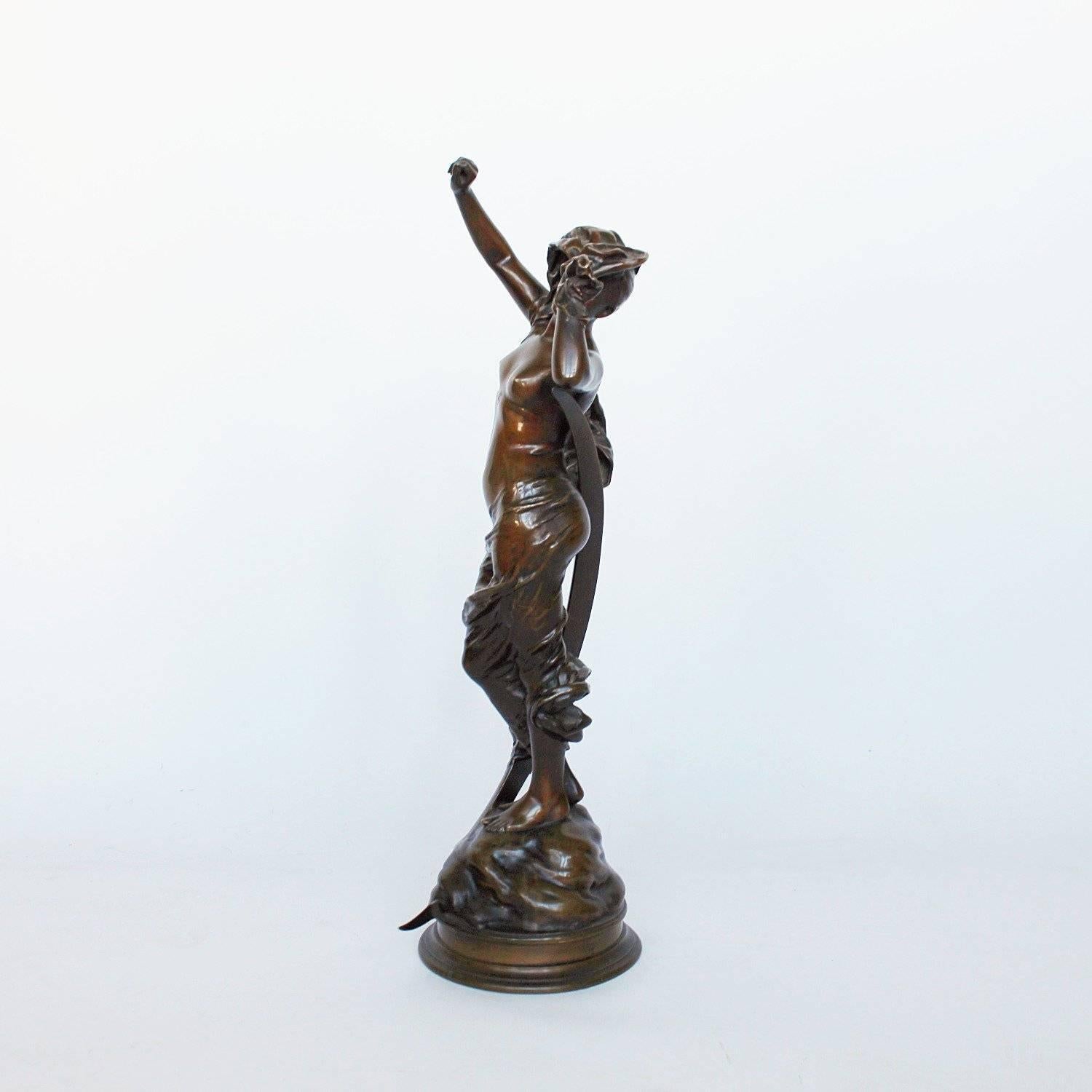 Selene, an Art Nouveau, patinated bronze sculpture of the moon goddess set over a revolving bronze plinth. Unsigned. Stamped 59290 to plinth.

 
