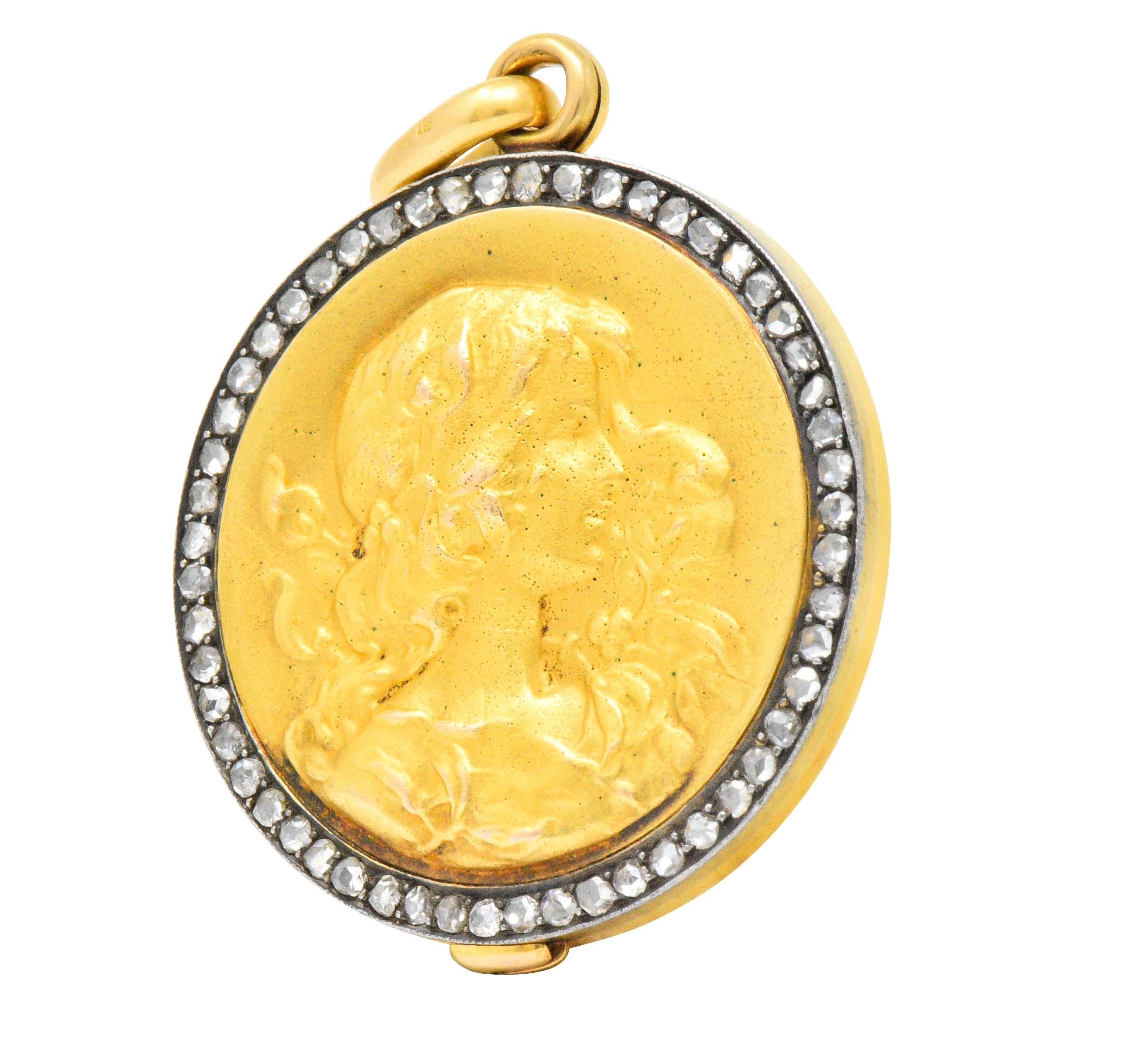 Centering repoussé matte gold profile of a lady 

With a rose cut diamonds surround

Beautifully detailed with flowing hair and flowers

Slide style, revealing two circular recessed frames, glass deficient

Inscribed on verso with 